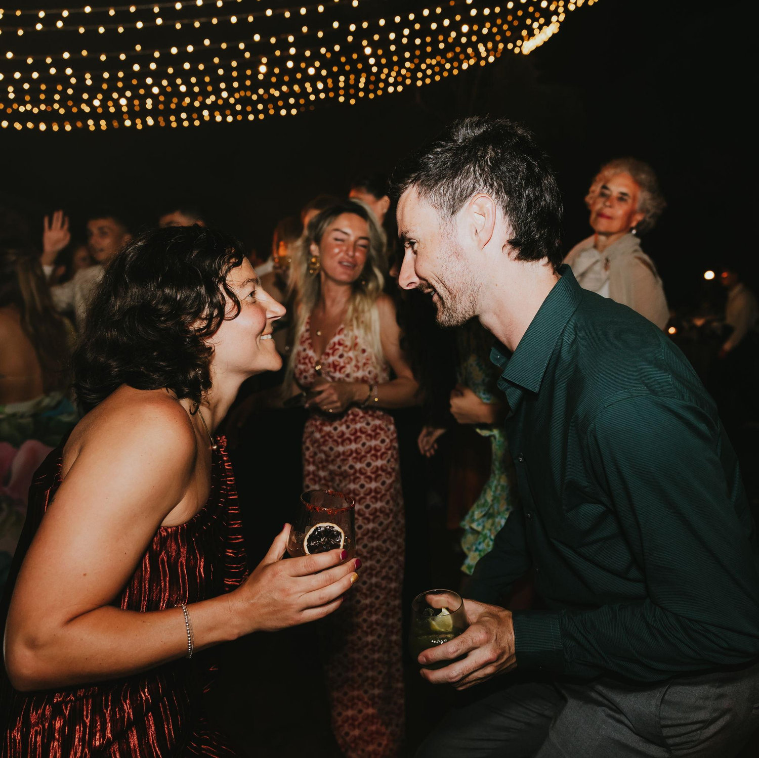 Drinks in hand, dancing, eyes locked.