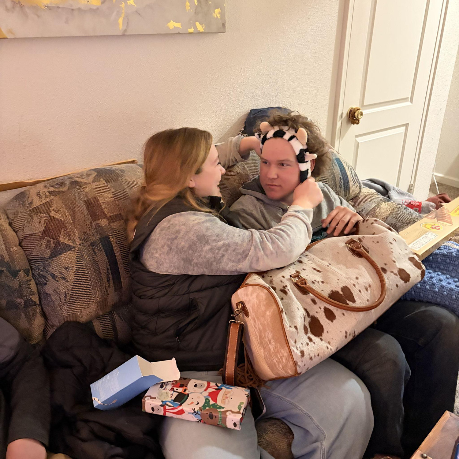 Christmas gift opening, 2025. Jonathan loves a good headband to hold back his precious locks.