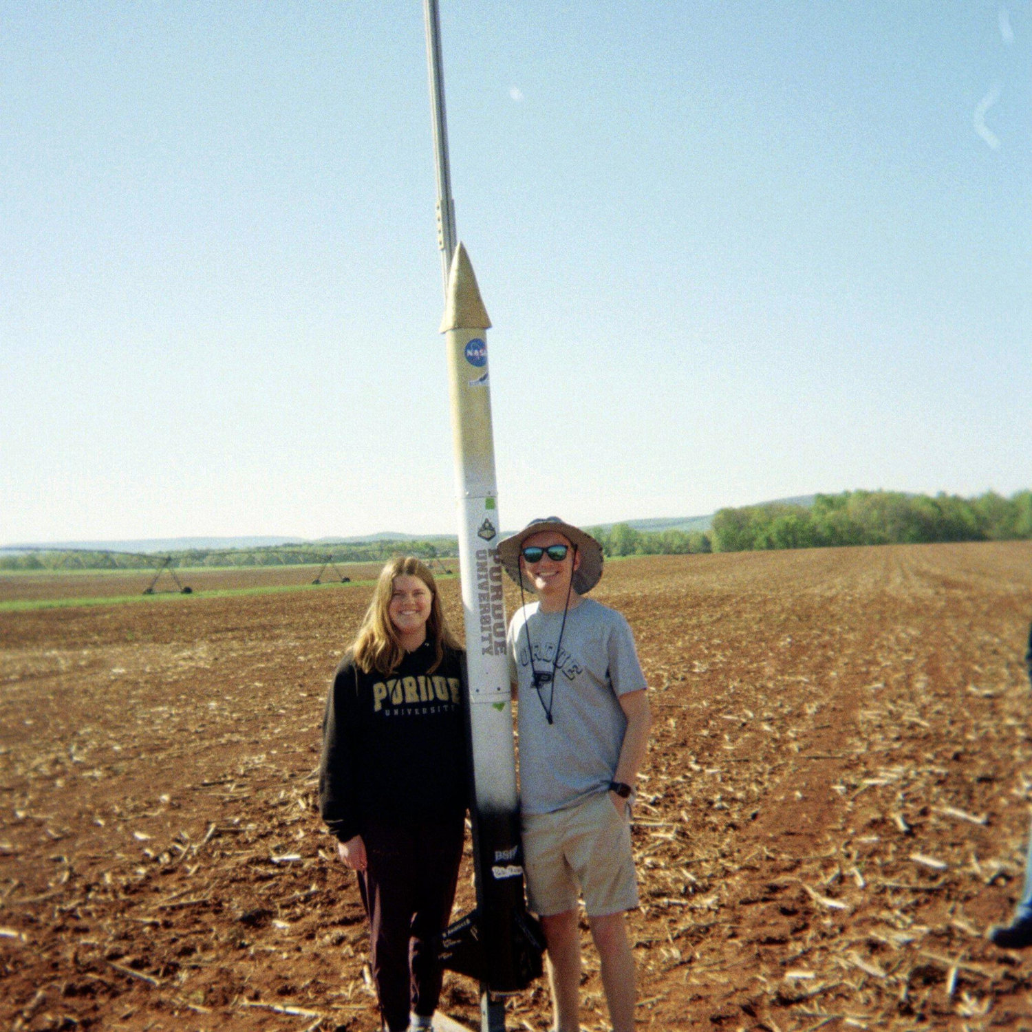 Camille and Alex standing next to the Purdue NASA Student Launch competition rocket in Huntsville in April 2024.