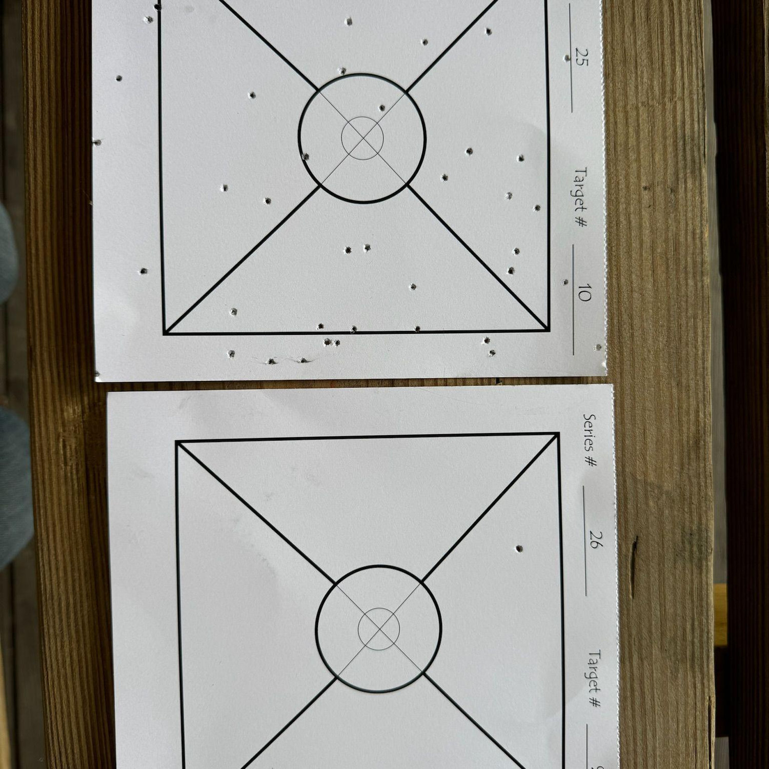 Darren's target vs. Ashleigh's target.
Technically speaking, she still hit the paper.