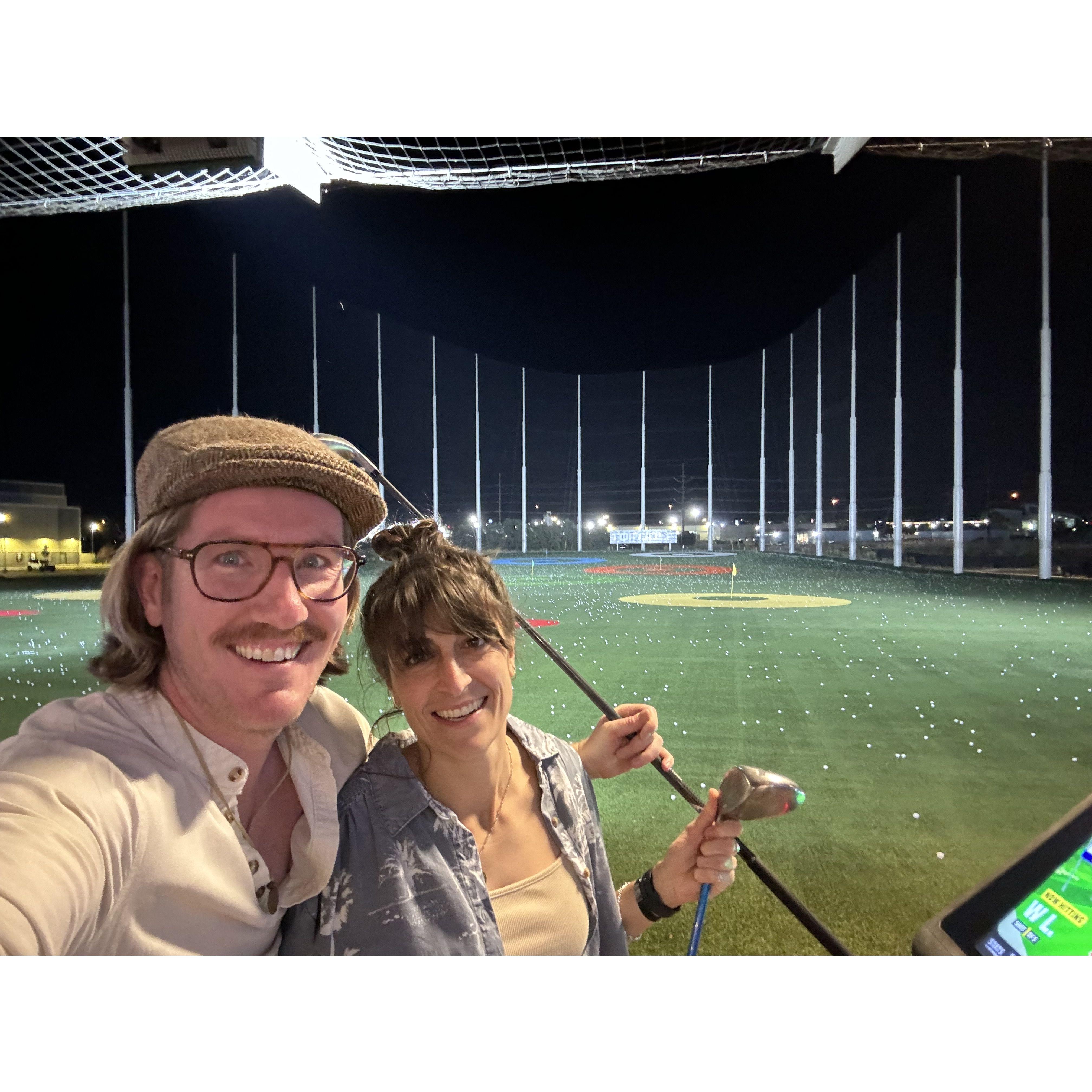 Top golf date night. John is a much better golfer than Whit.