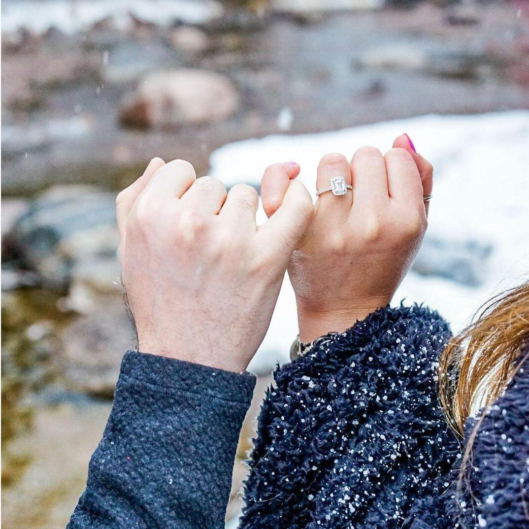 Close up of the engagement ring. Emerald cut with a halo setting!