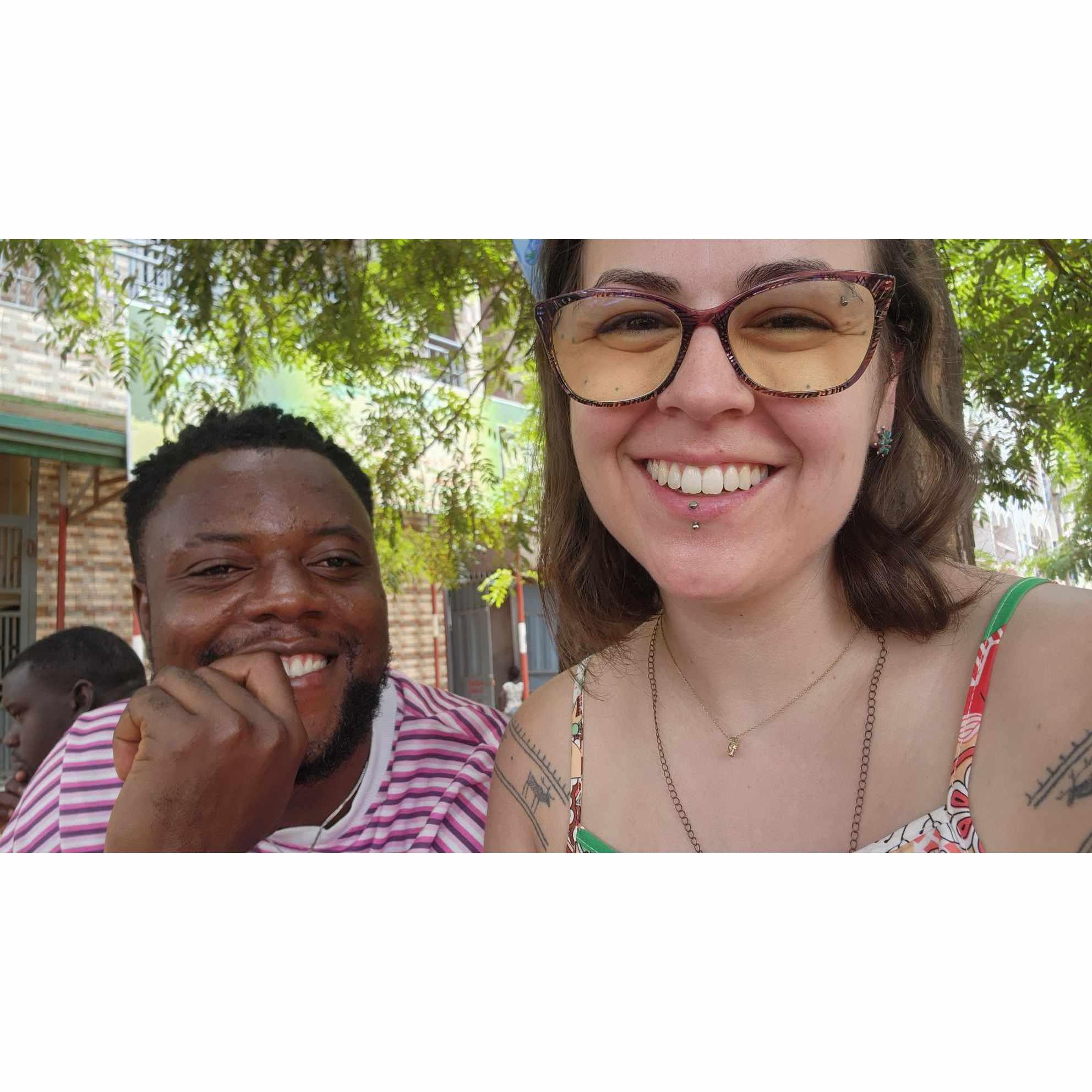 Waiting in the shade while tires were swapped on the busy roadside in Conakry, June 2024.
