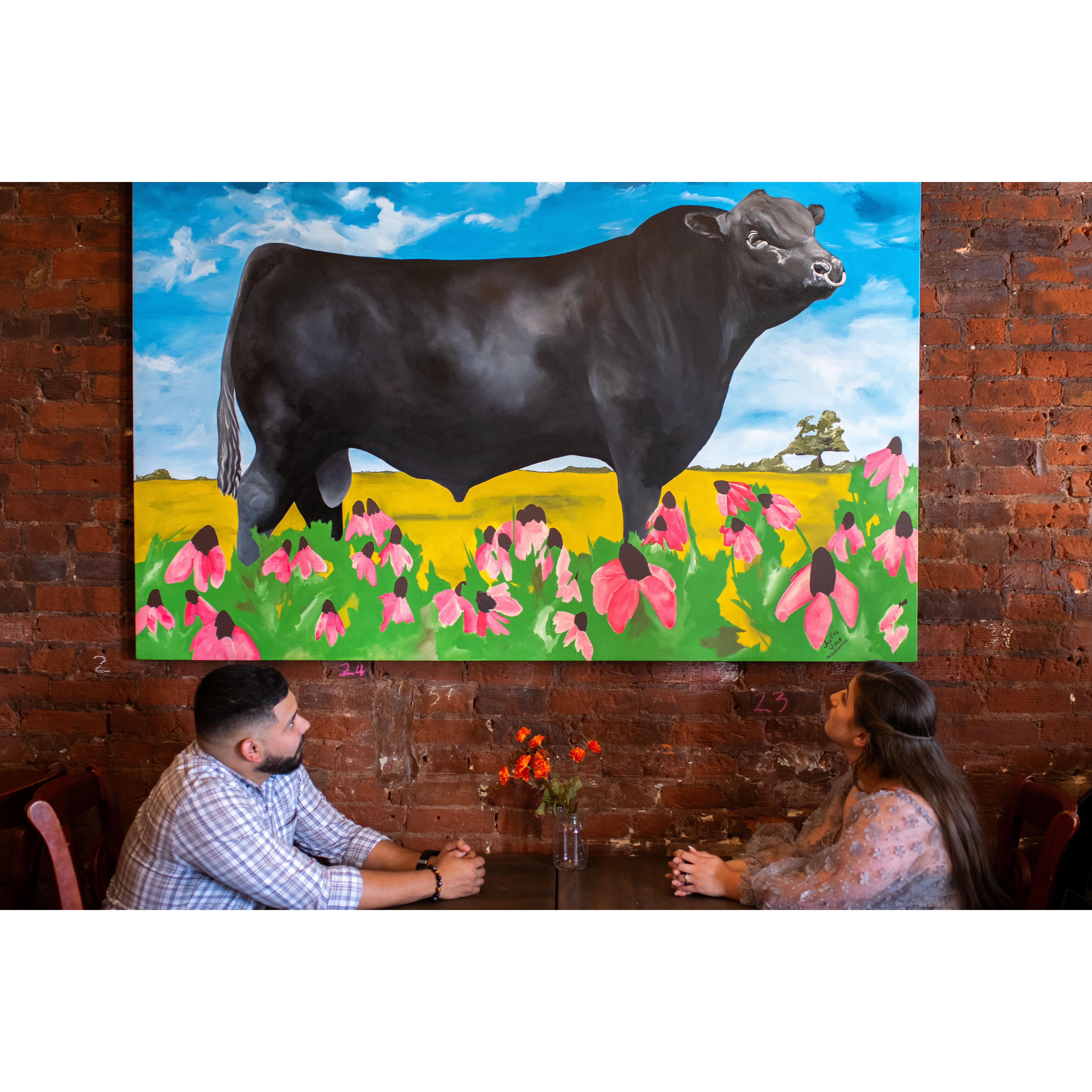 Engagement Picture! This was taken inside the coffee shop. Coffee and cows, what could be a better combination?—a picture taken by Ryan Hooper.