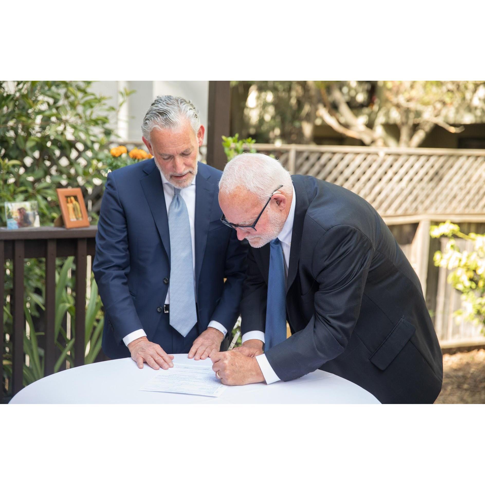 Rachel's Uncle Jeff and Rachel's father, Mike, signing the marriage license as witness