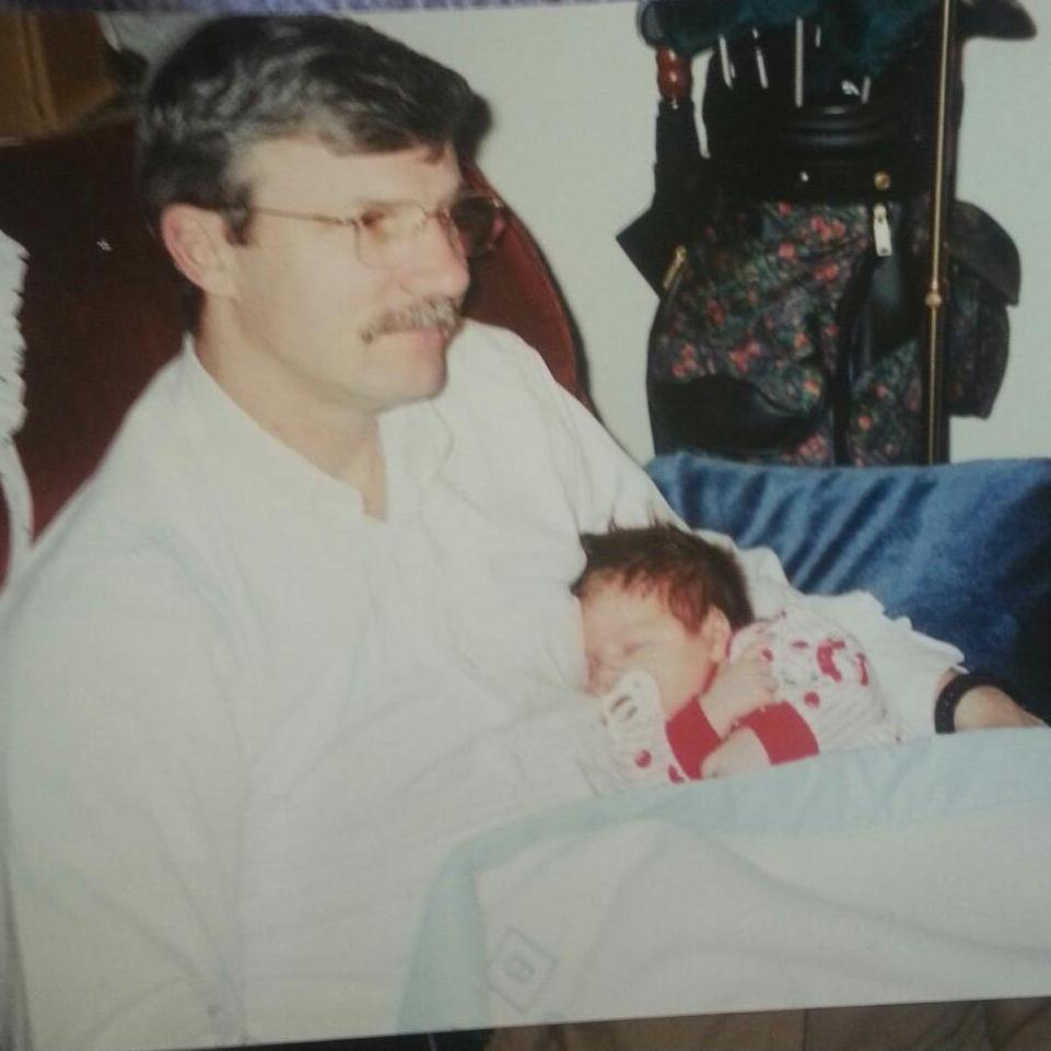 Baby Justin being held by his dad, Tom 1997