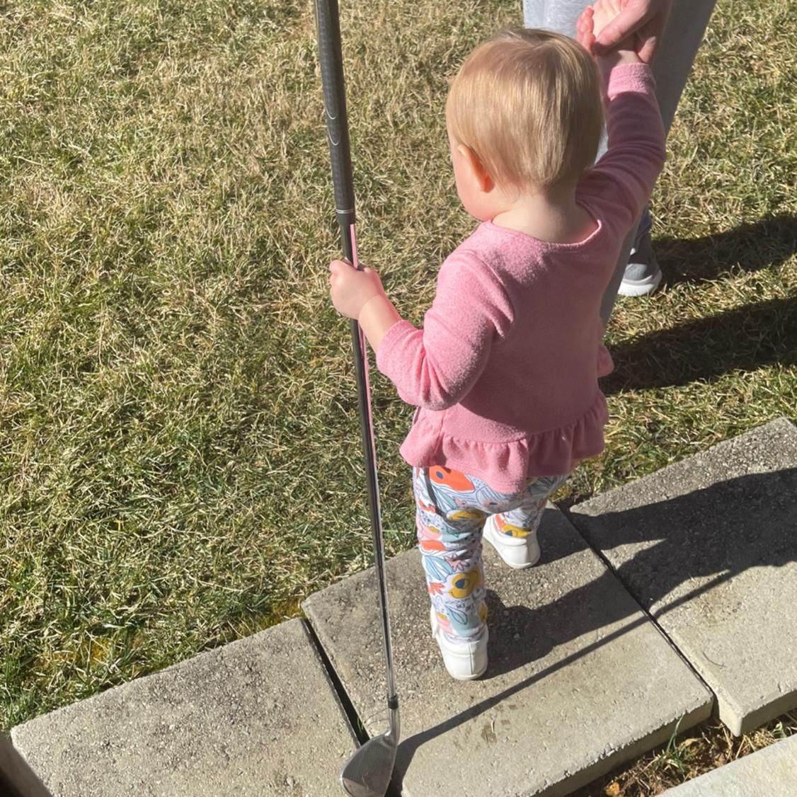 Daddy teaching Evie how to play golf!