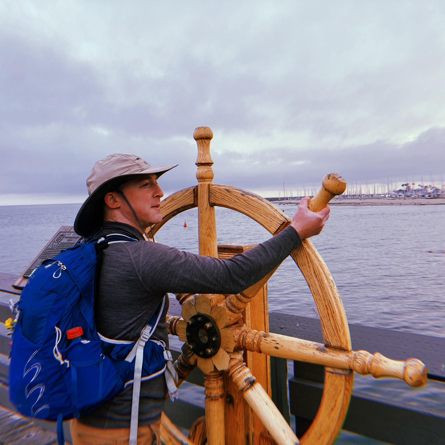 Peter posing with a ship's wheel on a day-date to Santa Barbara, long before we knew we'd one day have our own boat for him to captain!