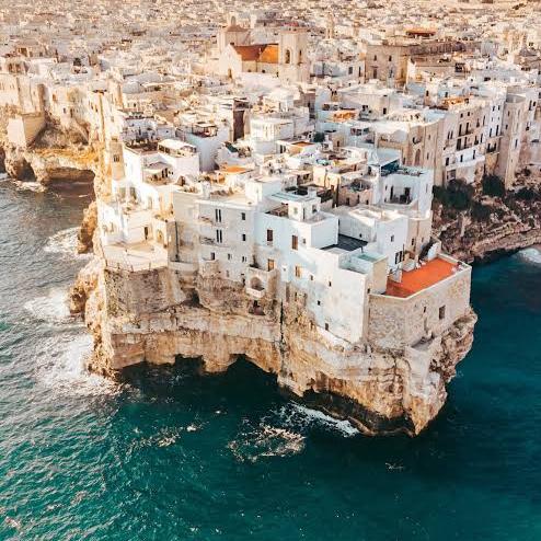 Polignano a Mare is a stunning coastal town perched dramatically on limestone cliffs above the Adriatic Sea. Known for its crystal-clear waters, hidden sea caves, and panoramic cliffside views.