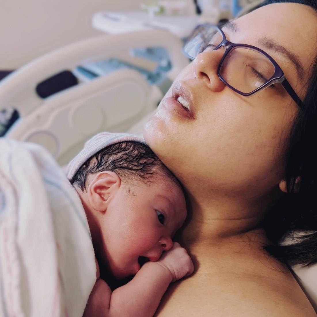 A very sleepy mommy and an equally sleepy baby. Charlotte is six minutes old in this picture.