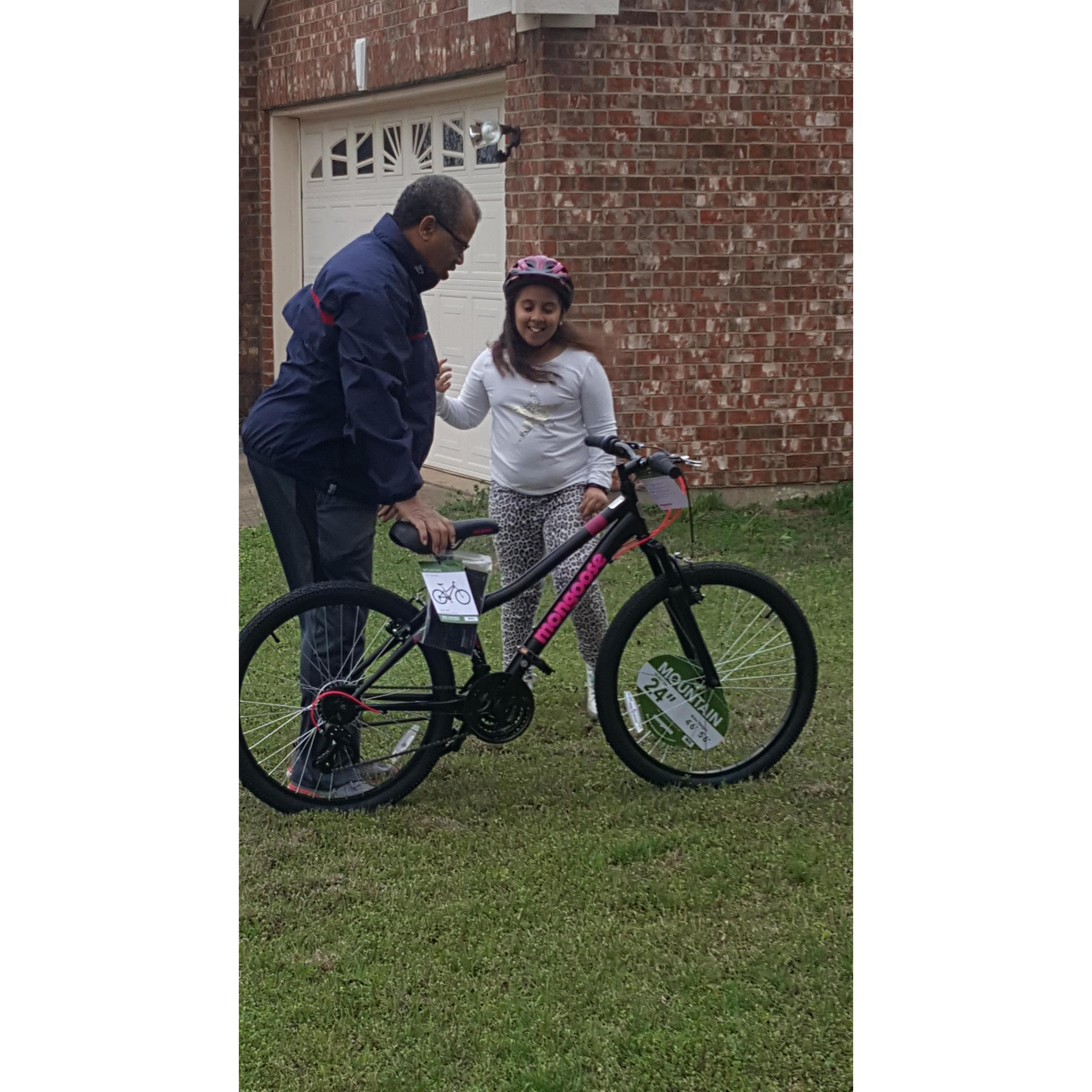 Bernard teaching Gabby to ride a bike without training wheels