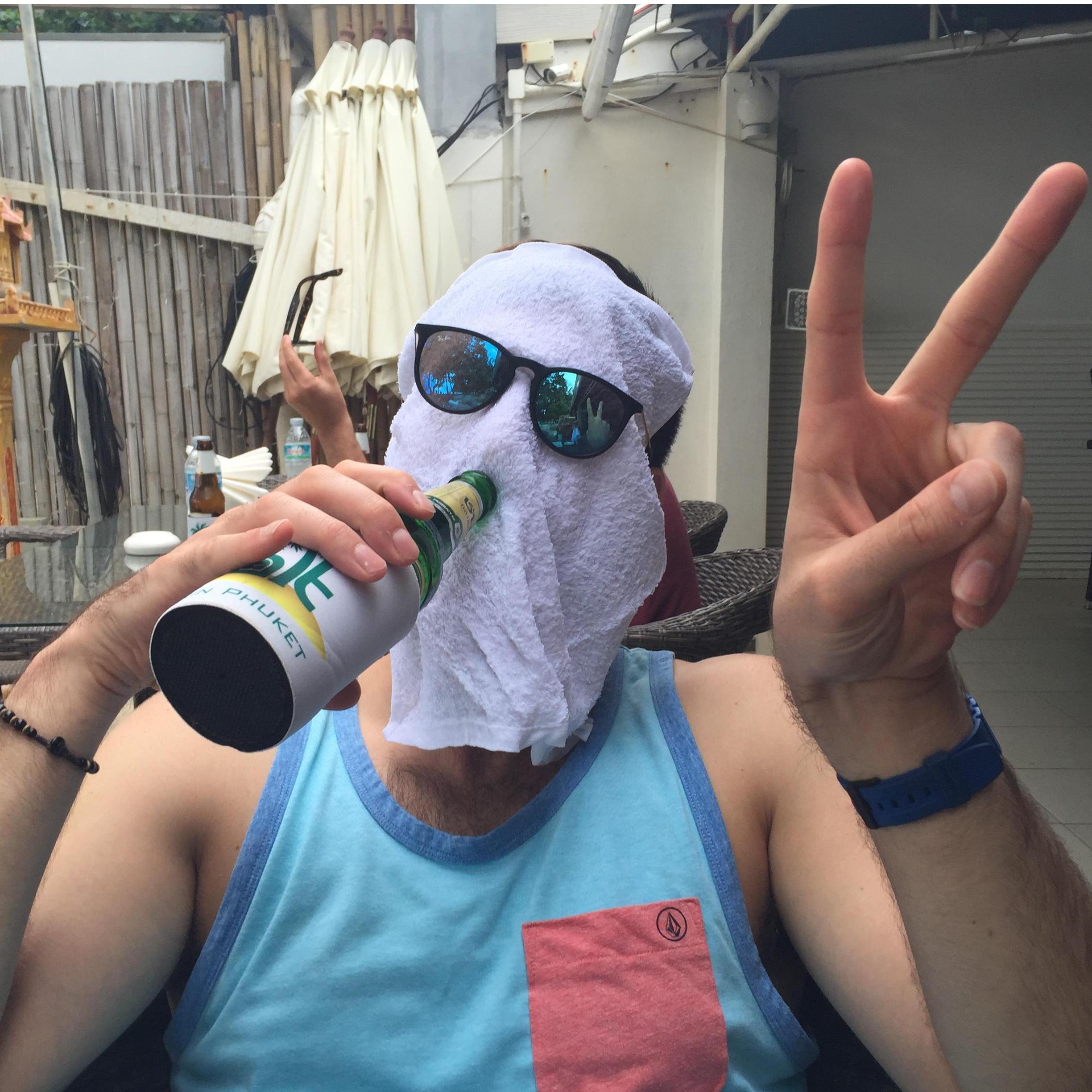 Napkin head sucking down some beers somewhere on a beach in Thailand.