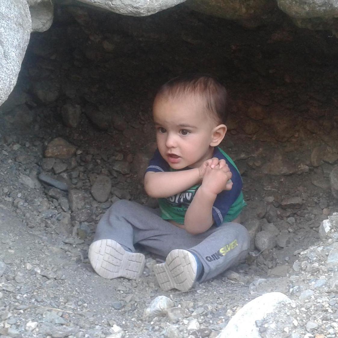 Orion sitting in a mini cave on our Silverwood Lake hike.