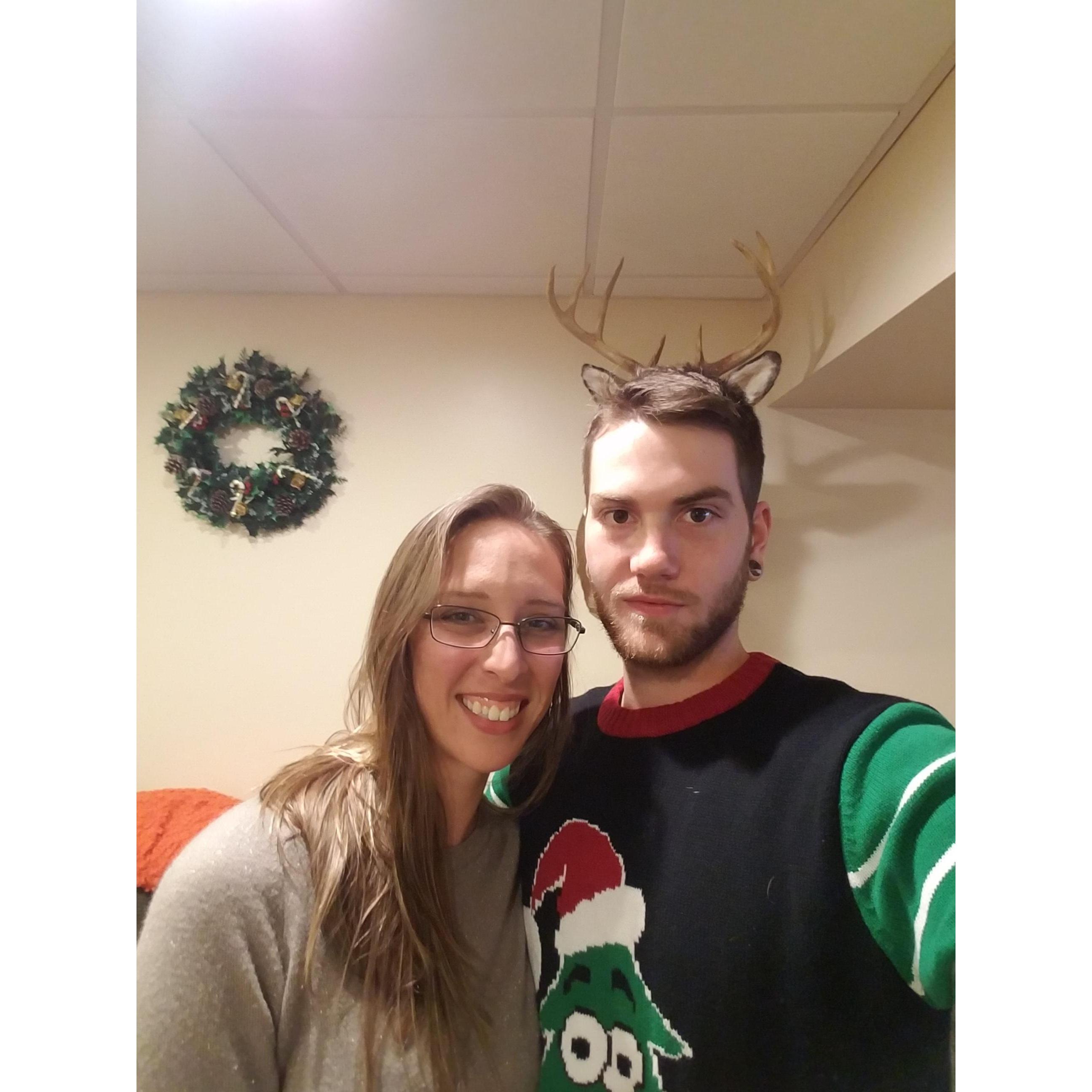 Here Erika is trying to get a nice photo, and Aaron is concentrating on making it look like he has antlers from the deer head hanging on the wall behind him. haha