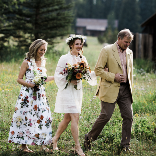 Grace's parents, Susan and Fred, walk her down the "aisle".