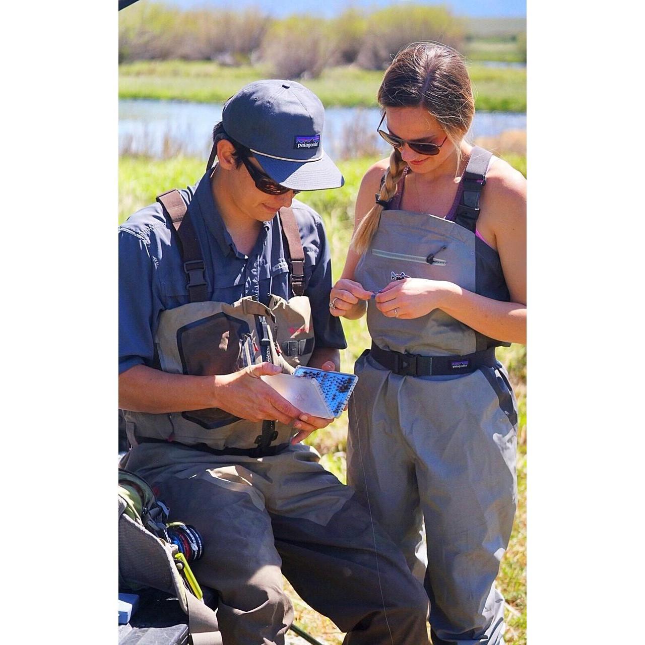 Tom being a very patient teacher showing Liz the ropes to fishing!