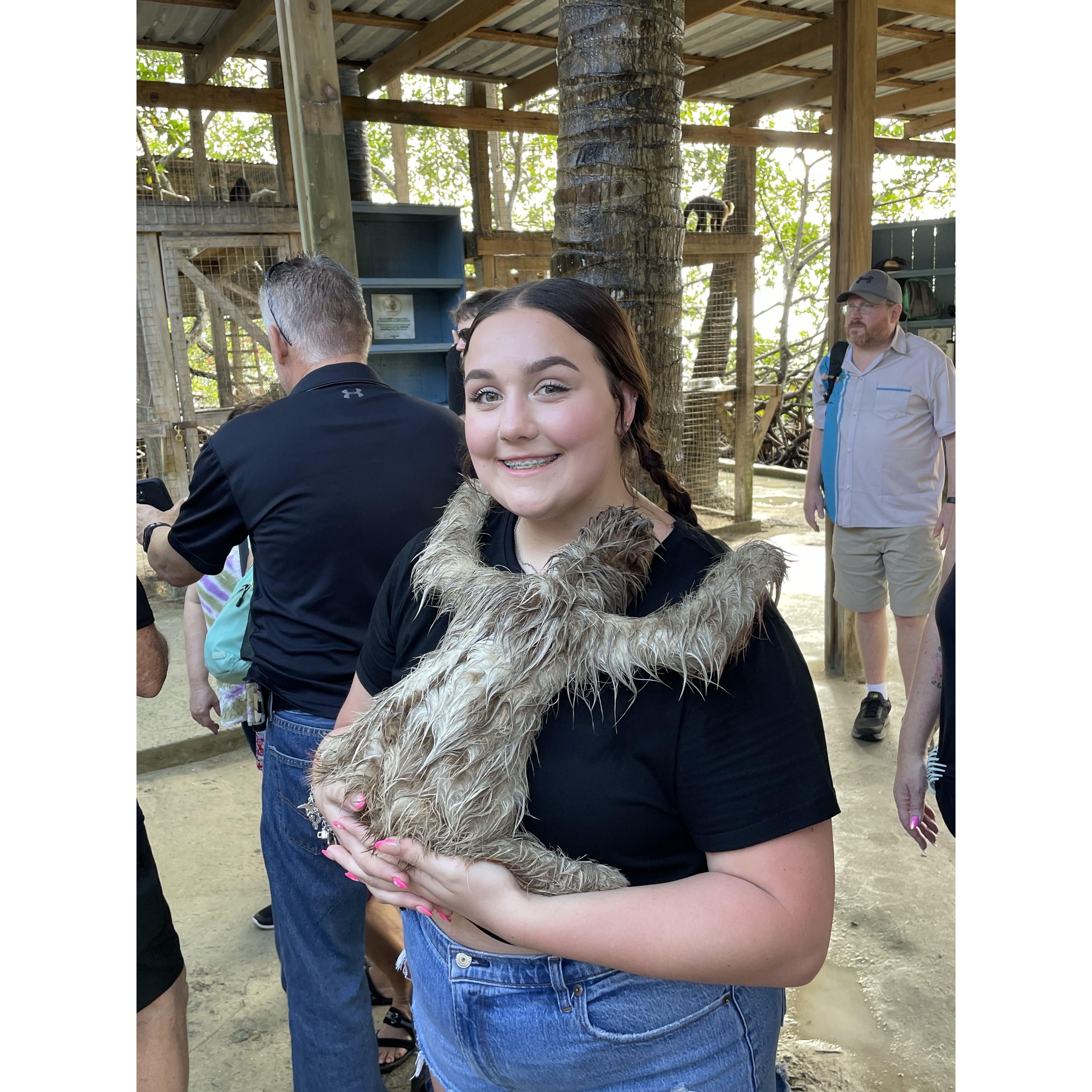 Maddie taking a picture with a sloth on our excursion in Roatan