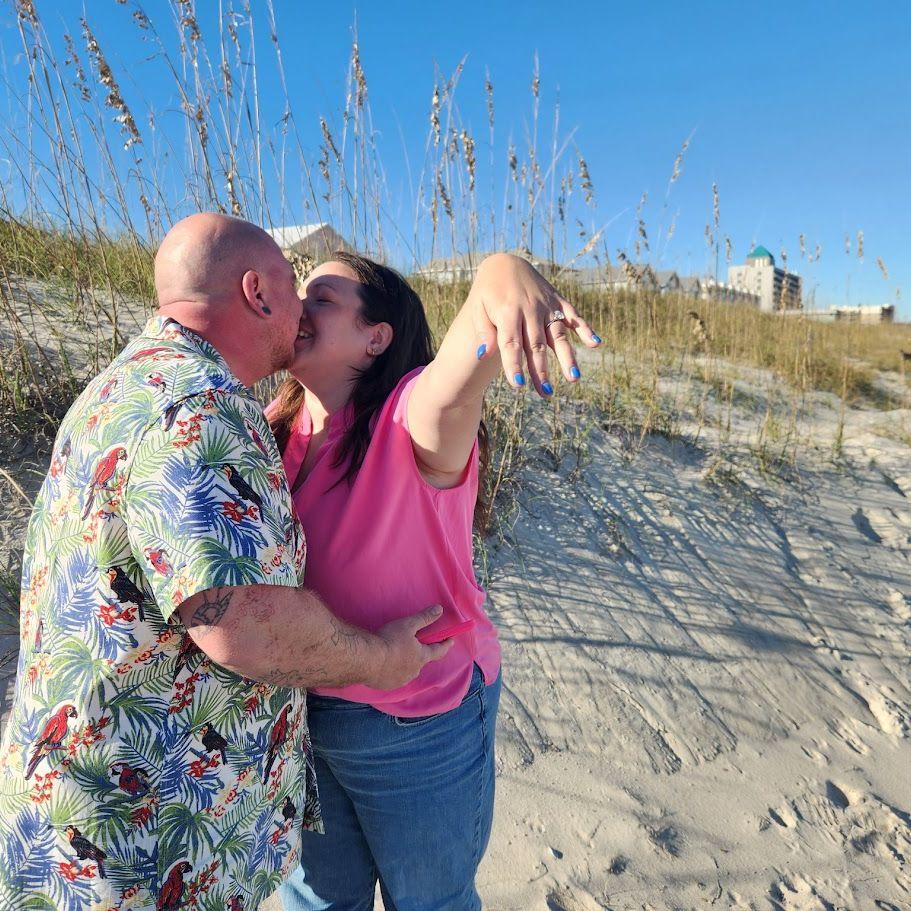 Anthony proposed on October 16th, 2025 in Carolina Beach, NC. Micayla was wearing hot pink Crocs. While excellent beach shoes, one may argue that Crocs are not great engagement shoes.