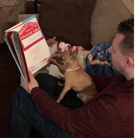 Kyle reading to Larry....both staying up on current events!