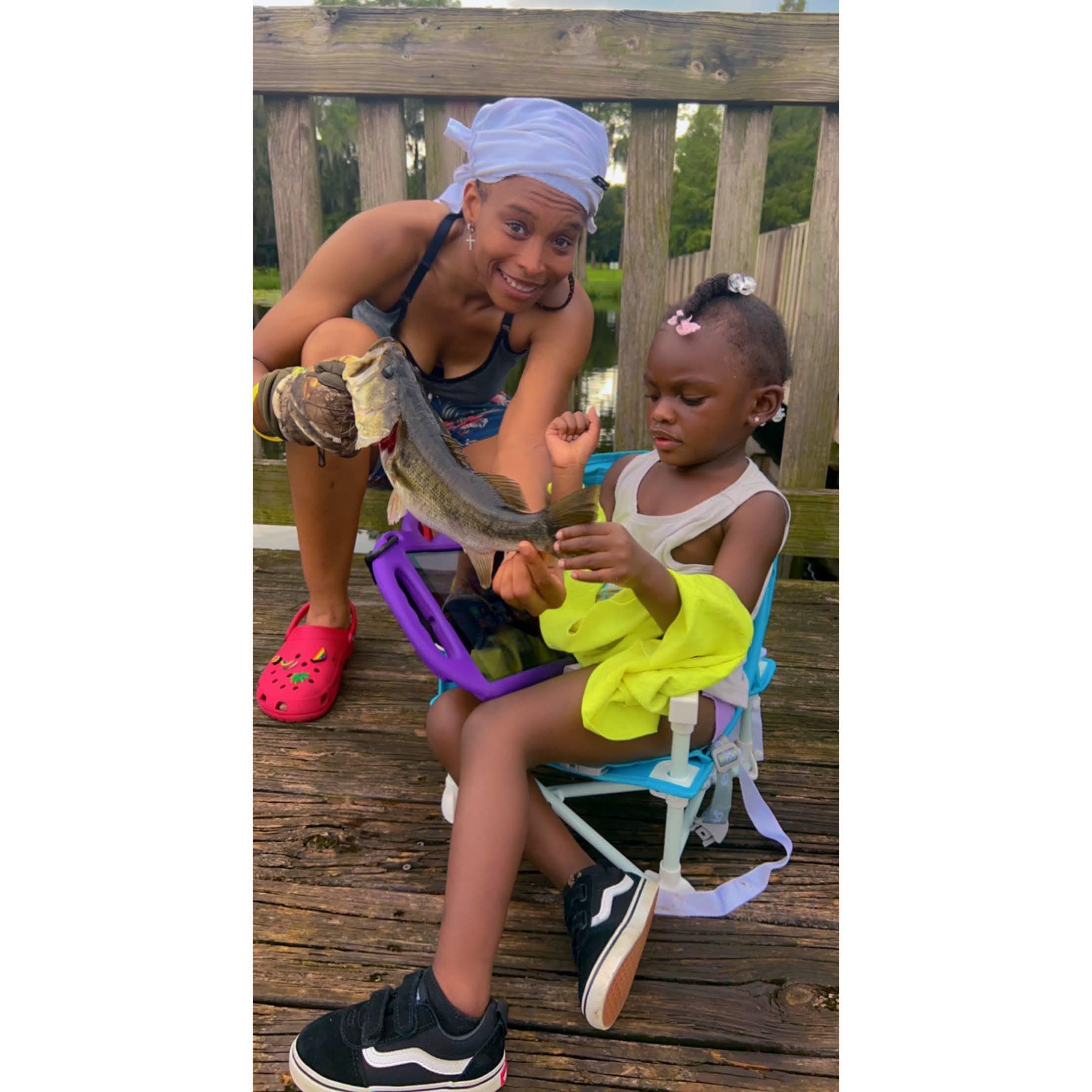 Shaniqua showing Aniyah the fish she caught.