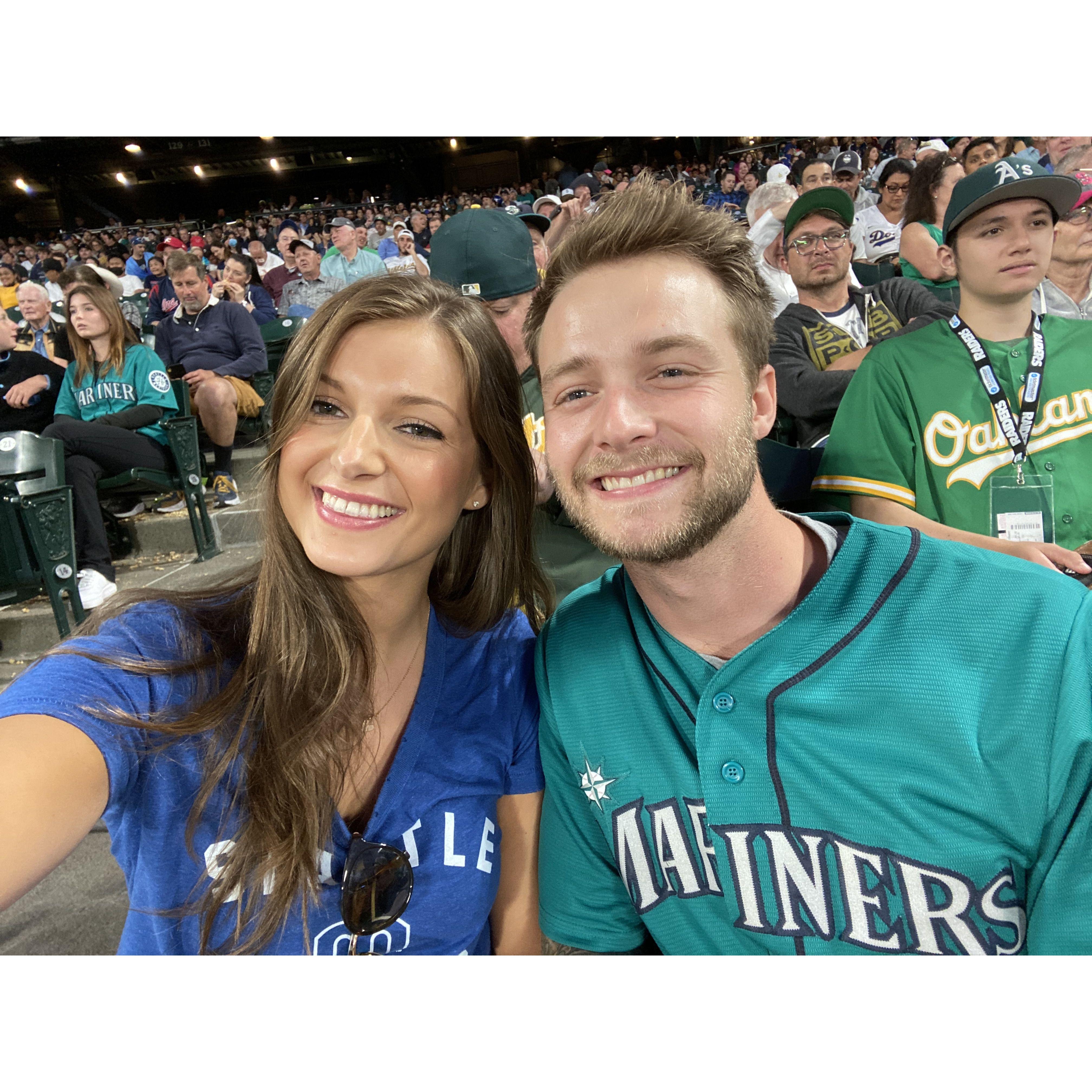 July 23, 2021: Our first photo together! Our 5th date at a Mariner's game