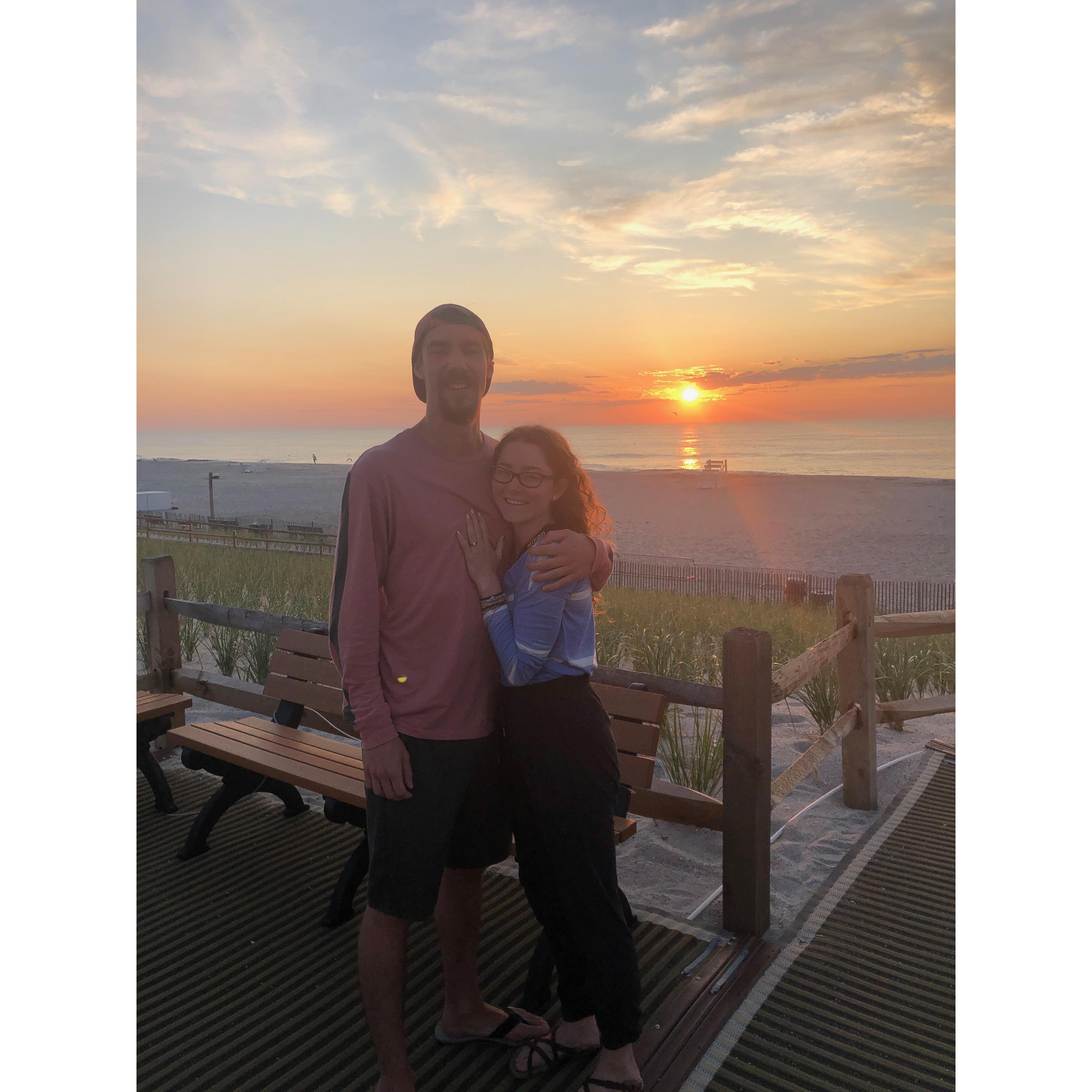 On the beach at sunrise, right after he proposed. Picture credit: random stranger.