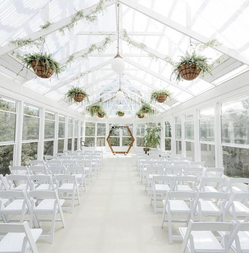 Iris aisle is a whimsical greenhouse tucked back in a cedar grove surrounded by nothing but the beauty of nature.