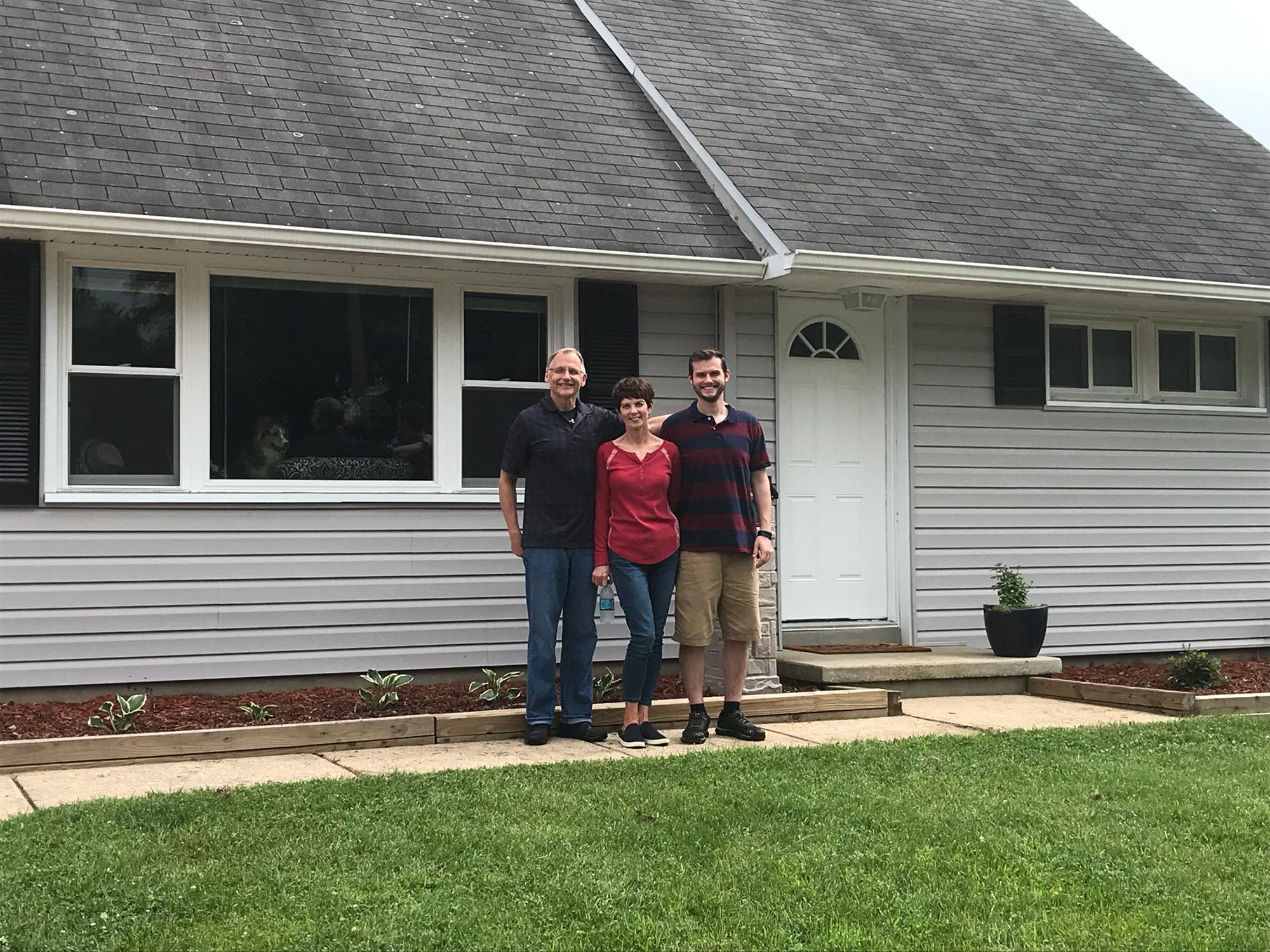 Eric and his parents in front of our first house!