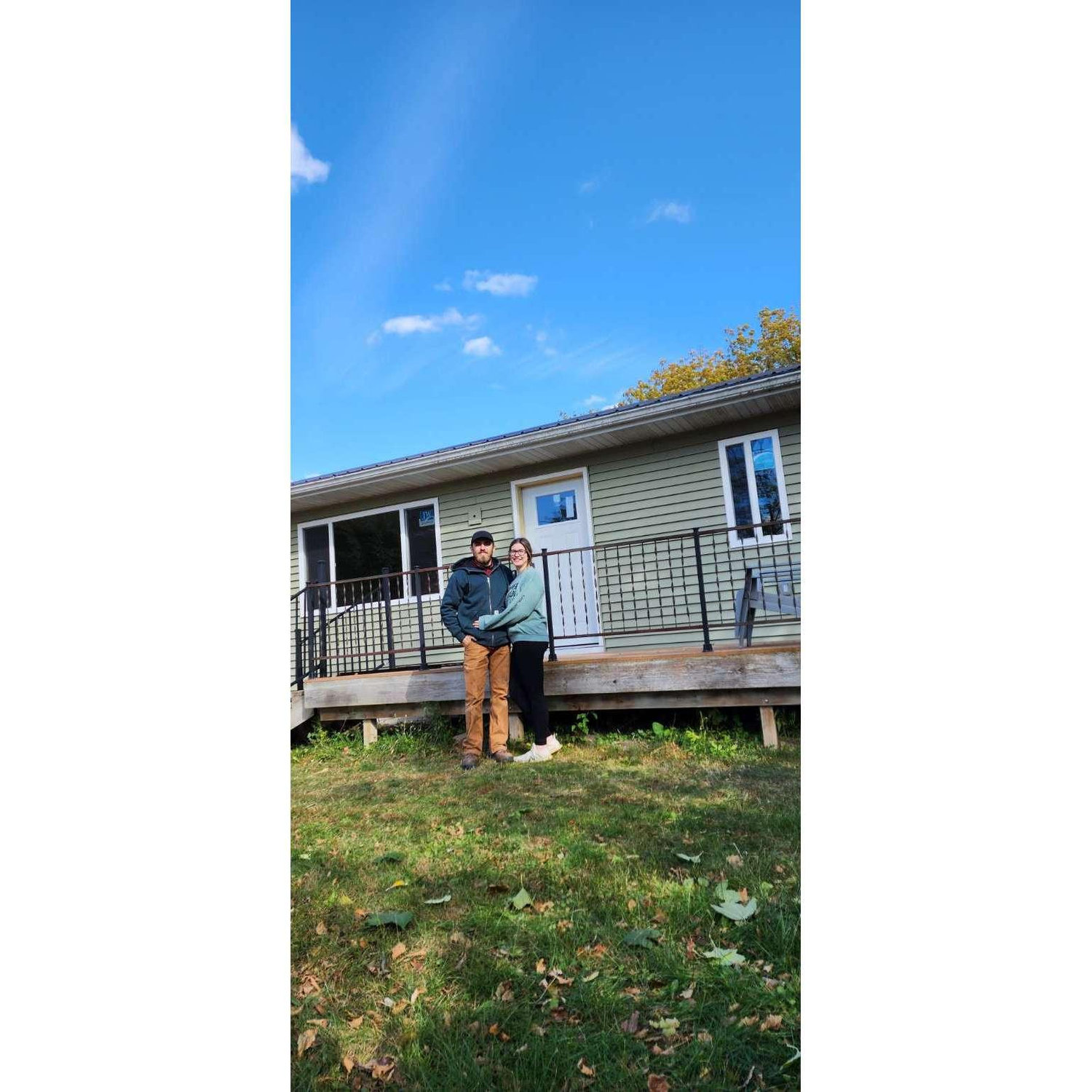 Outside of our house together! We had just finished replacing all of the siding, windows, and doors.