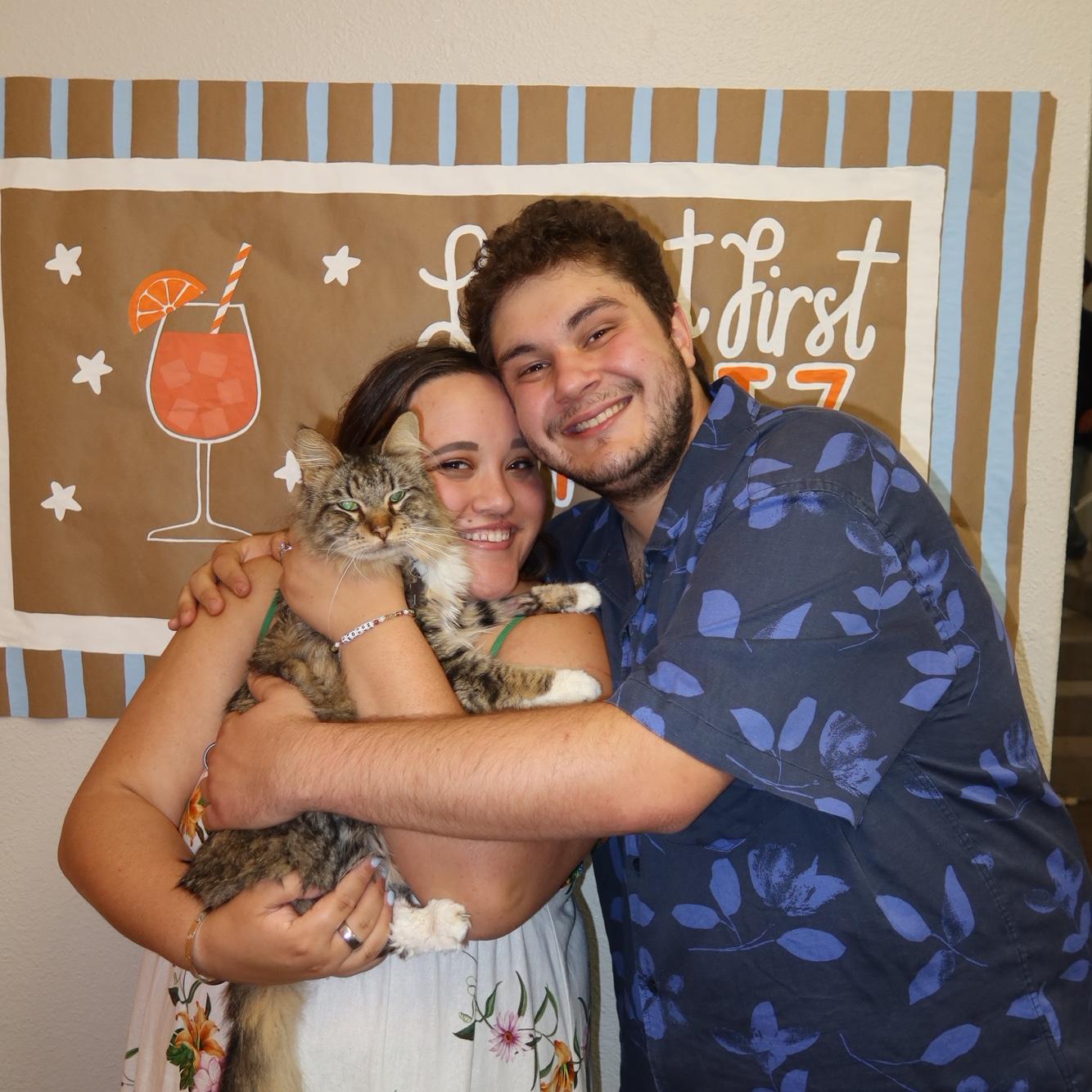 Jaxon, Caitlyn, and their cat George at their engagement party!