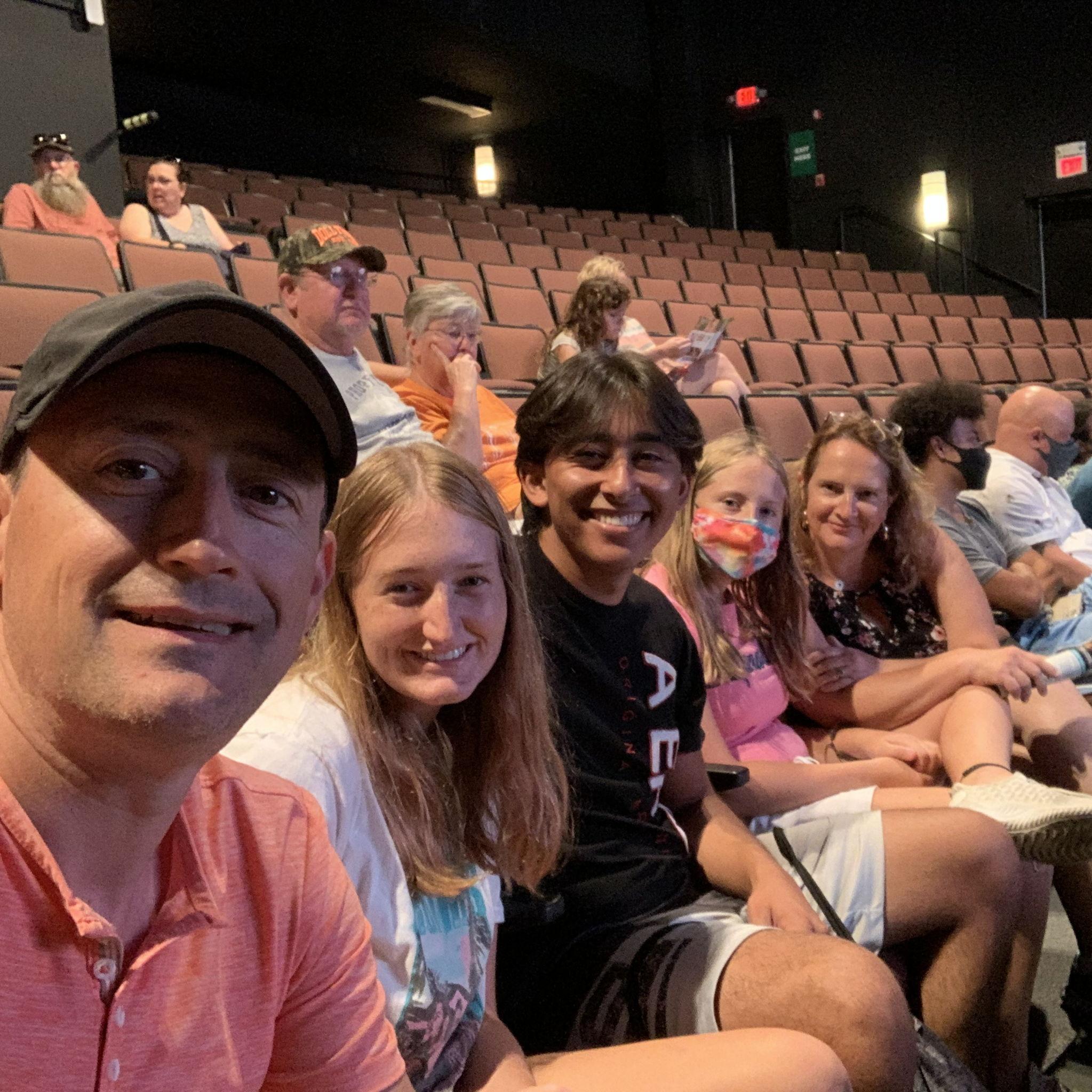 The bride, groom, & the bride's family watching a show
