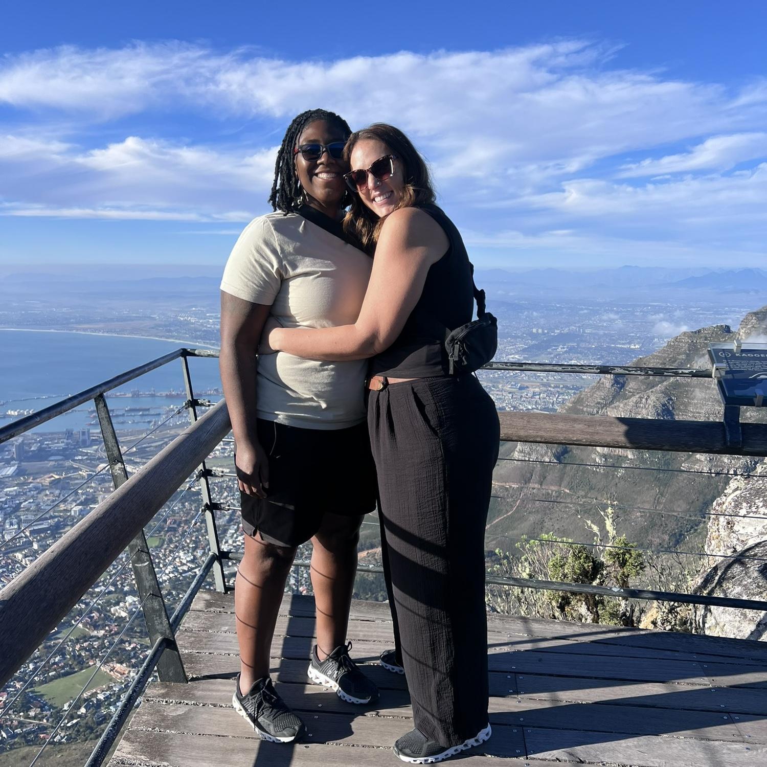 On top of Table Mountain in Cape Town. The man taking this photo said "you guys are a couple, right? Do couple things" hence this pose.
