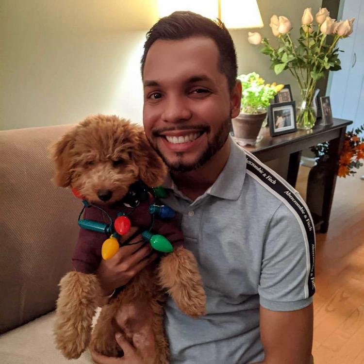 Diego dressed up in Christmas lights for a tree decorating party in Long Island City
