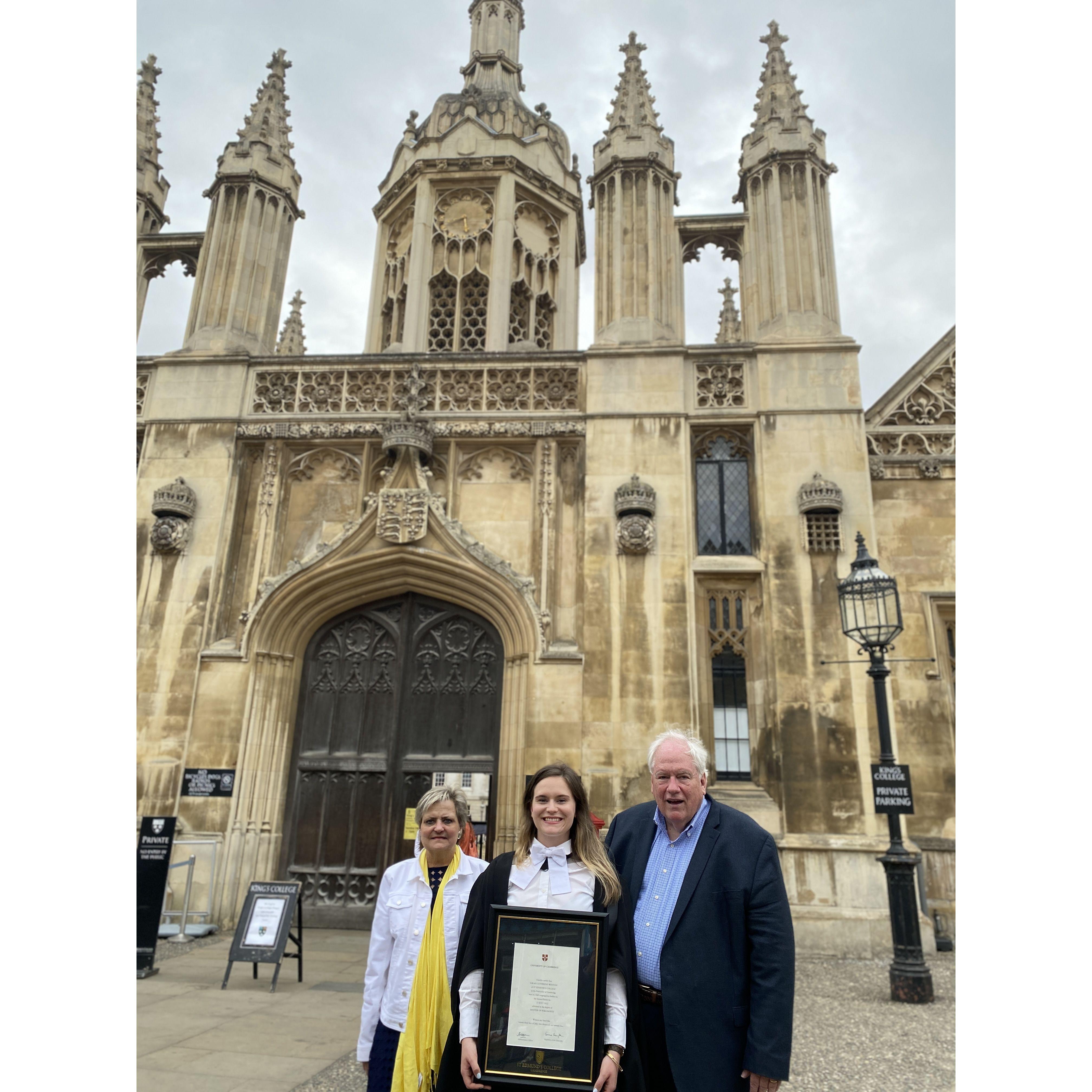 Sarah and her parents attending her graduation from the University of Cambridge.