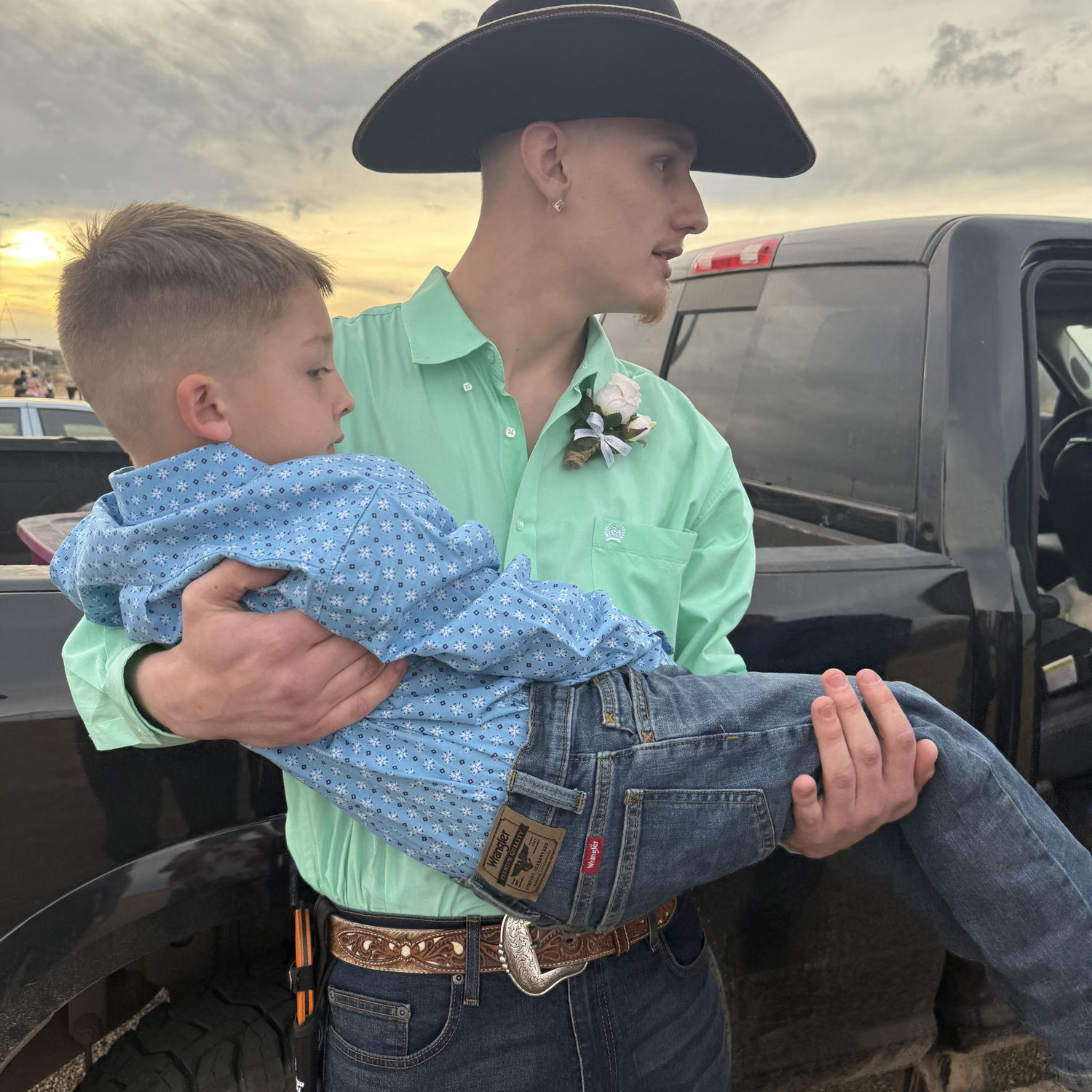 Groom holding his first baby