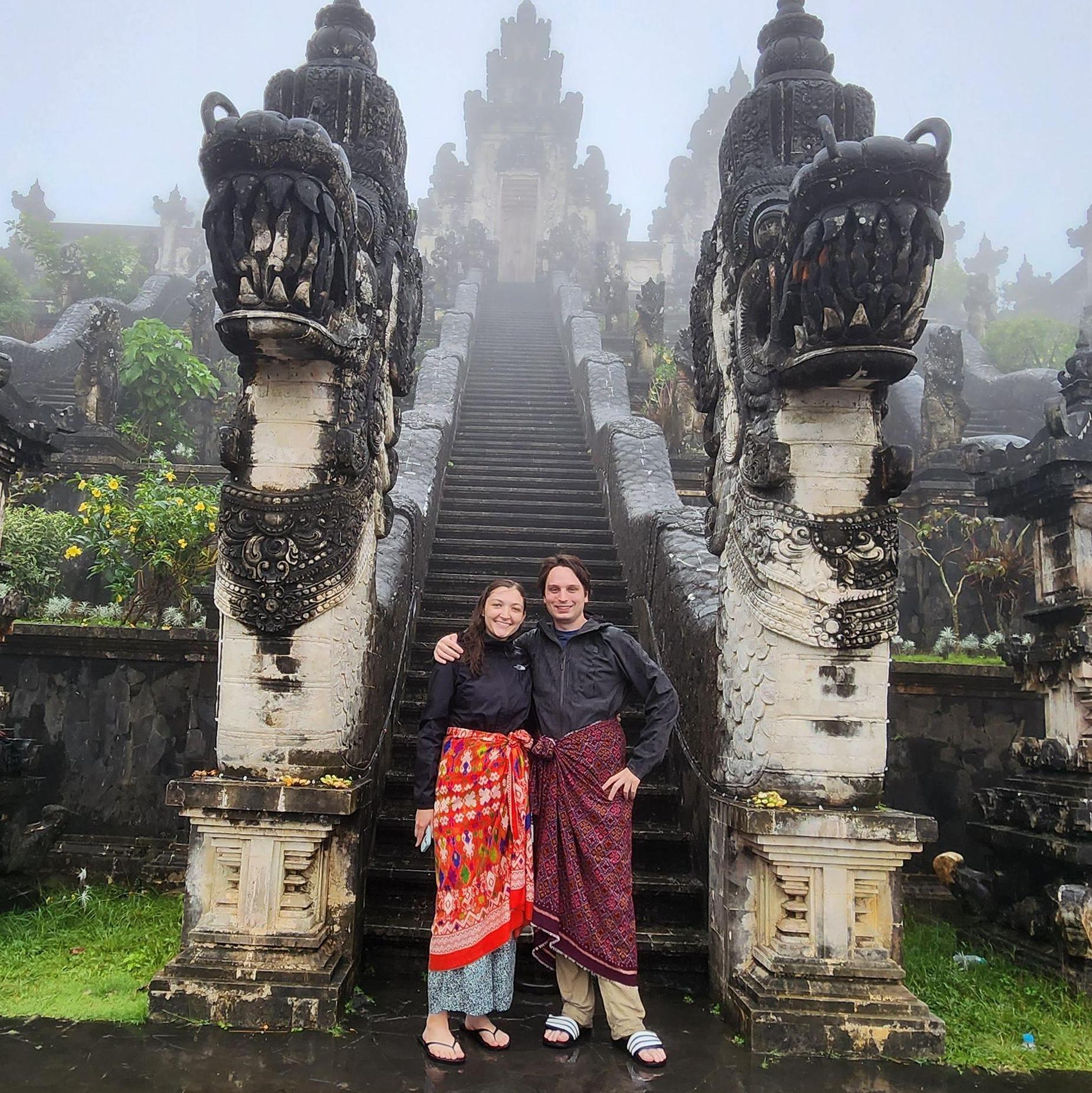 Visiting a temple in Bali - rocking sarongs in the rain!