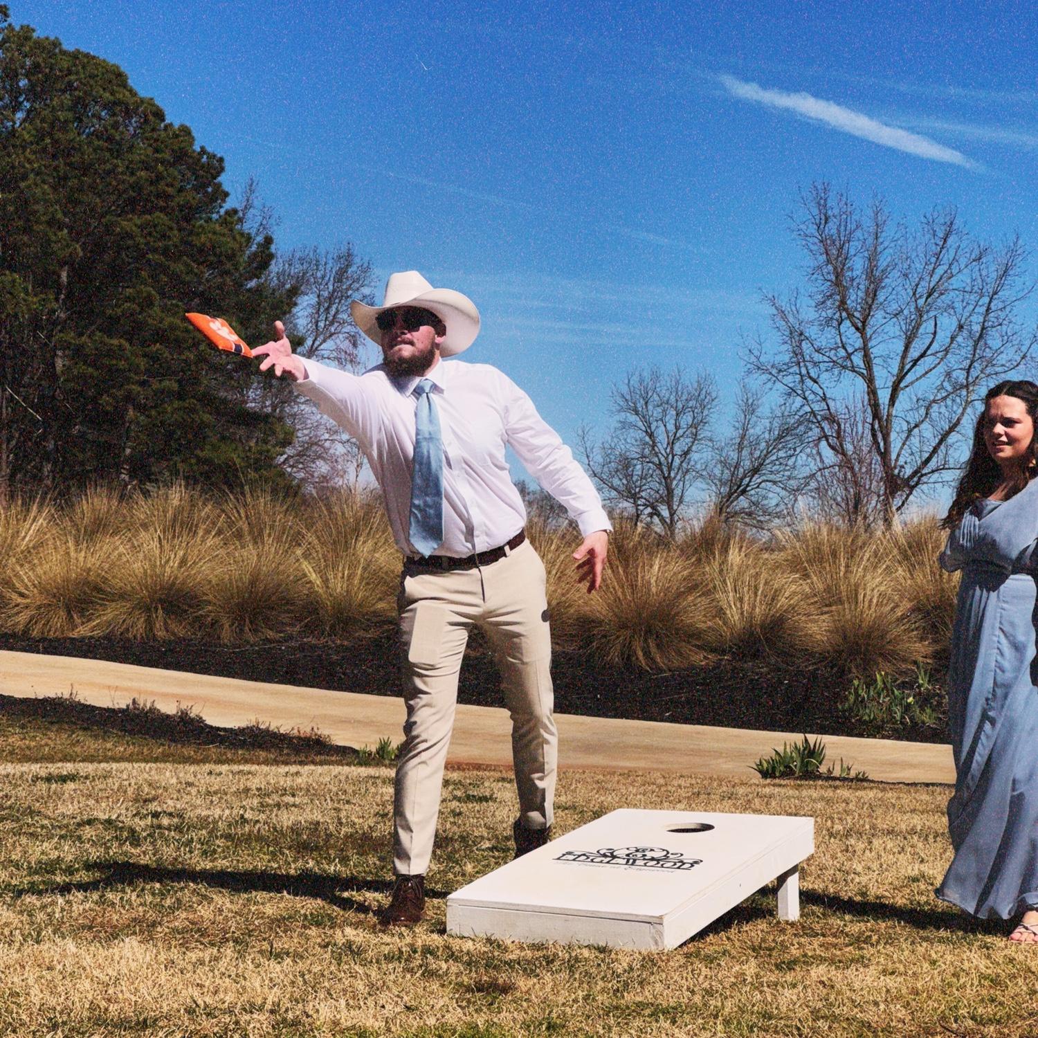 Us playing cornhole at Joy and Tyler’s wedding 2025!