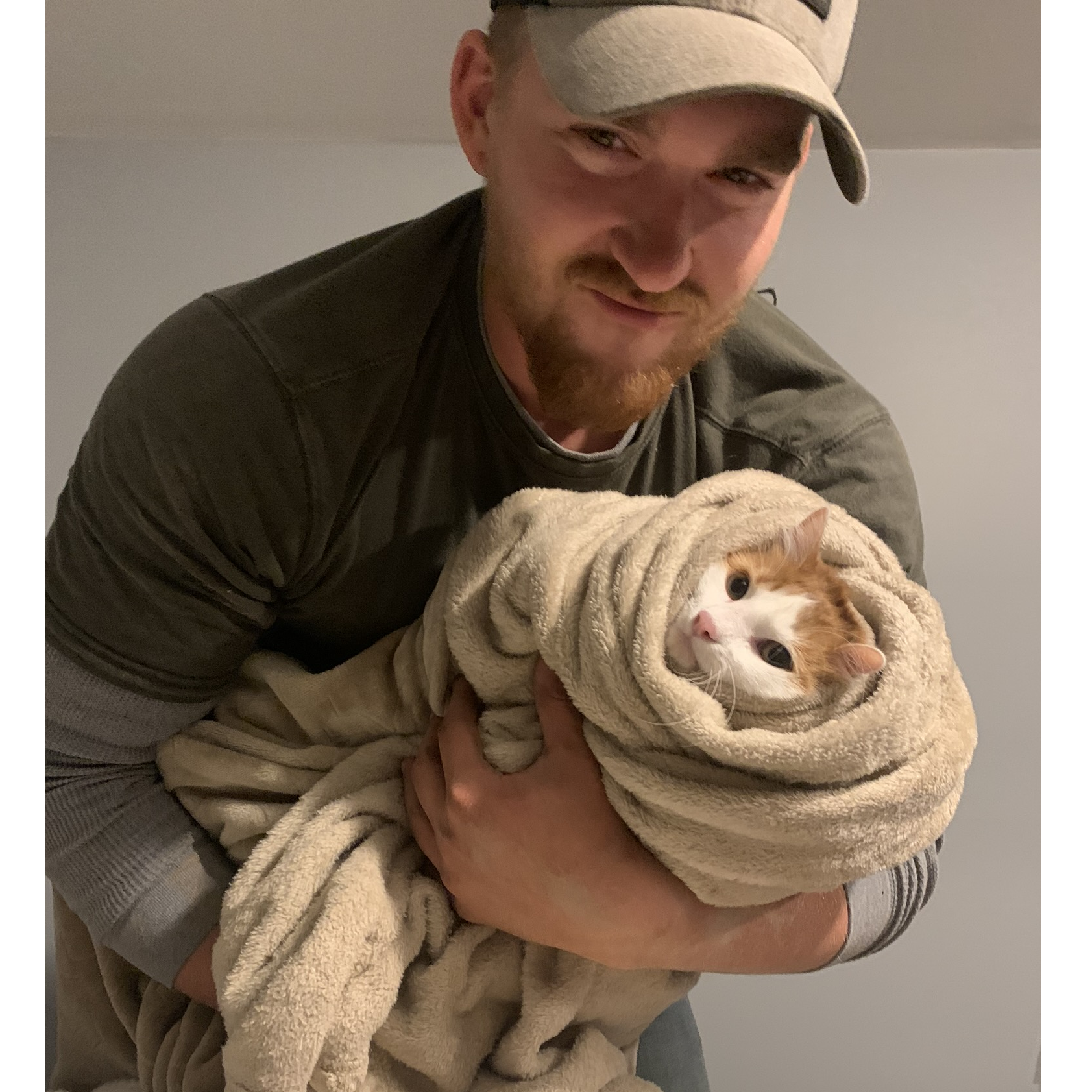 He came into this relatiionship not liking my cats, but I think things have changed. Nutmeg was wrapped like a kiity burrito here.