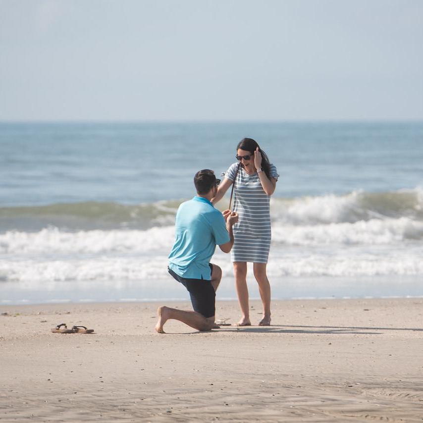There was a photographer, hiding as a beachgoer, snapping the whole proposal.