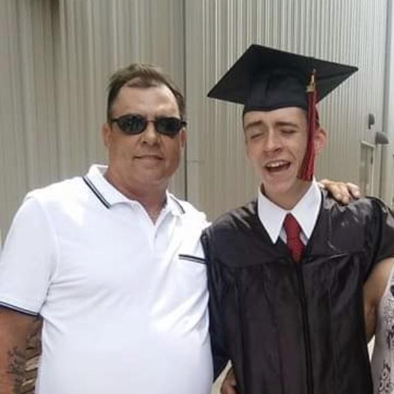 Remembering Tommy, Travis's late father . Here on the day of Travis graduation , it seems Travis had too much sun in his eyes!
