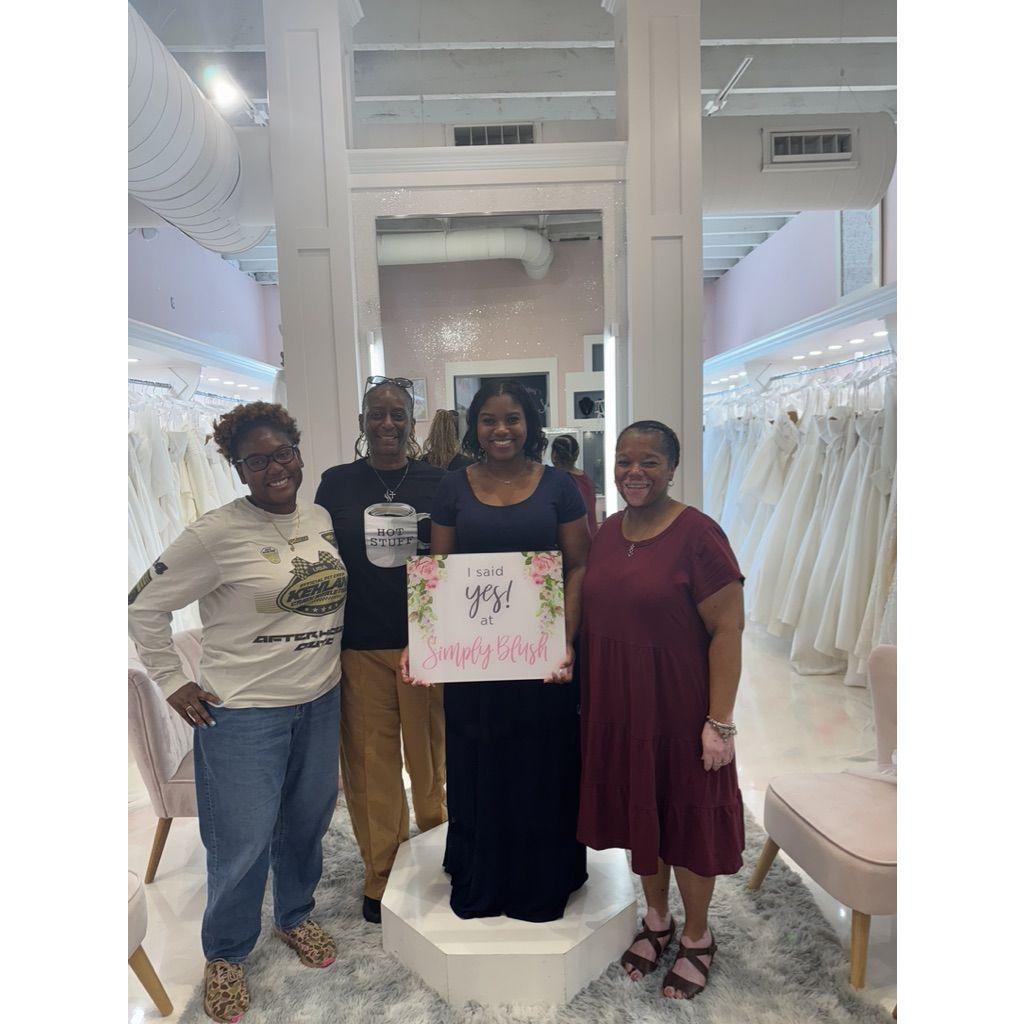 Michaela, Karen, and Takisha watch Destini say "yes" to the dress!