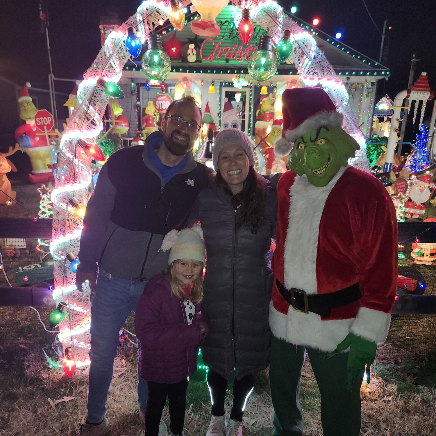Ben, Kaity, and Eloise with Ellie's favorite Christmas character, the Grinch!