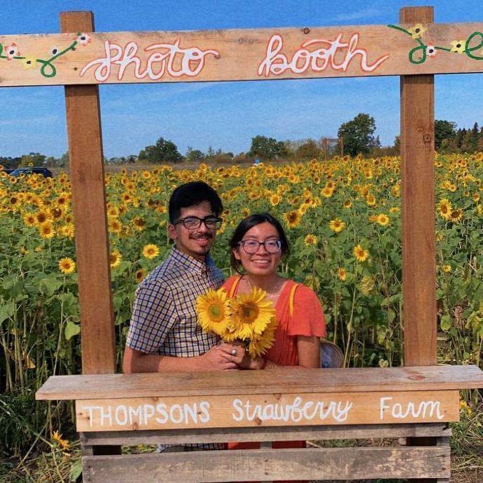 This is us in our favorite two things in the world -- strawberries & sunflowers!