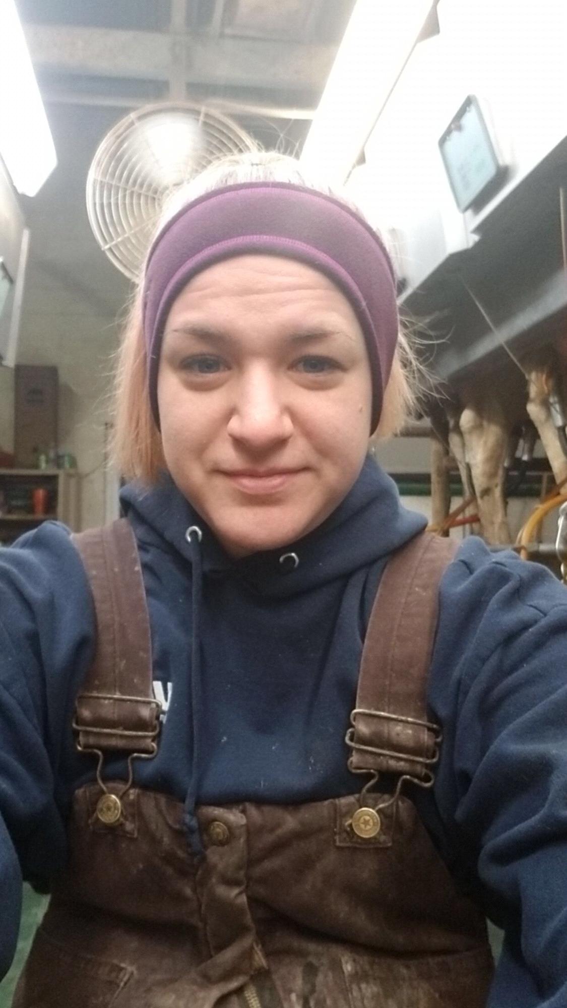 Joanne in one of her favorite places: the milking parlor! 💜🐮🐄💜