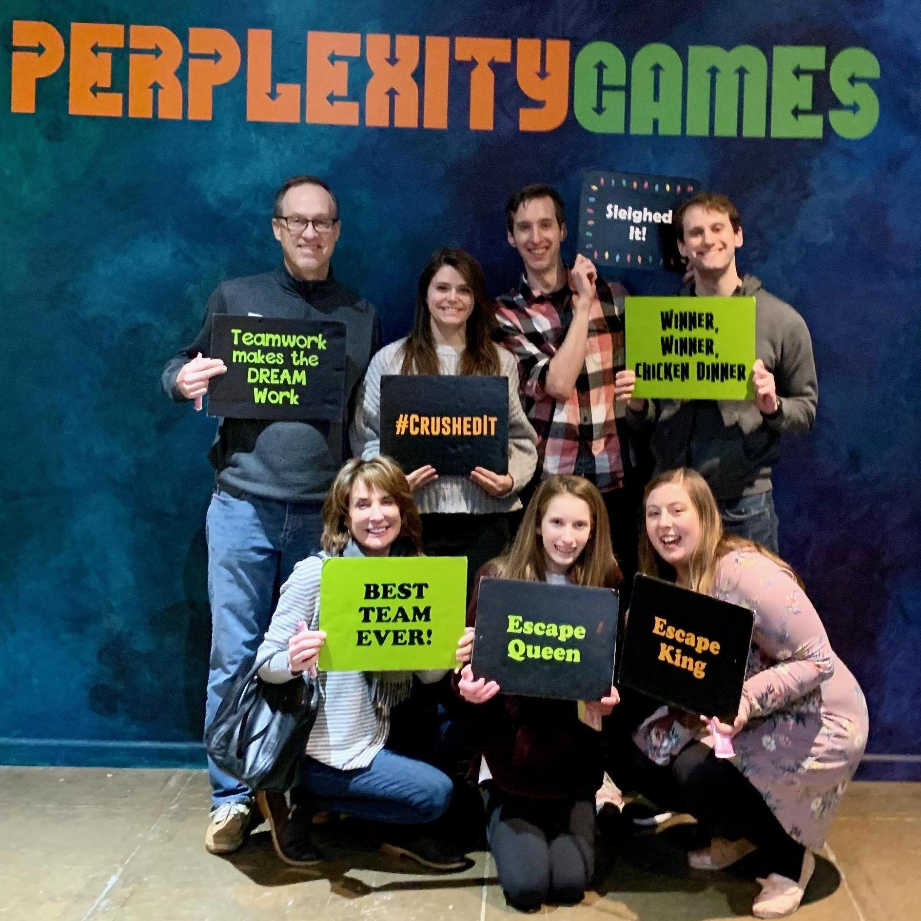 The couple with family after successfully escaping an escape room.