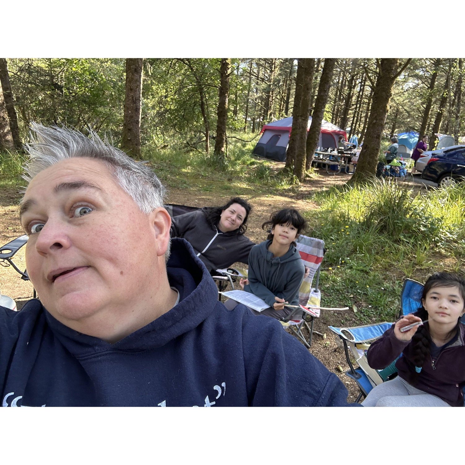Our family while camping. There may or may not be some cross wording and knife brandishing going on here!