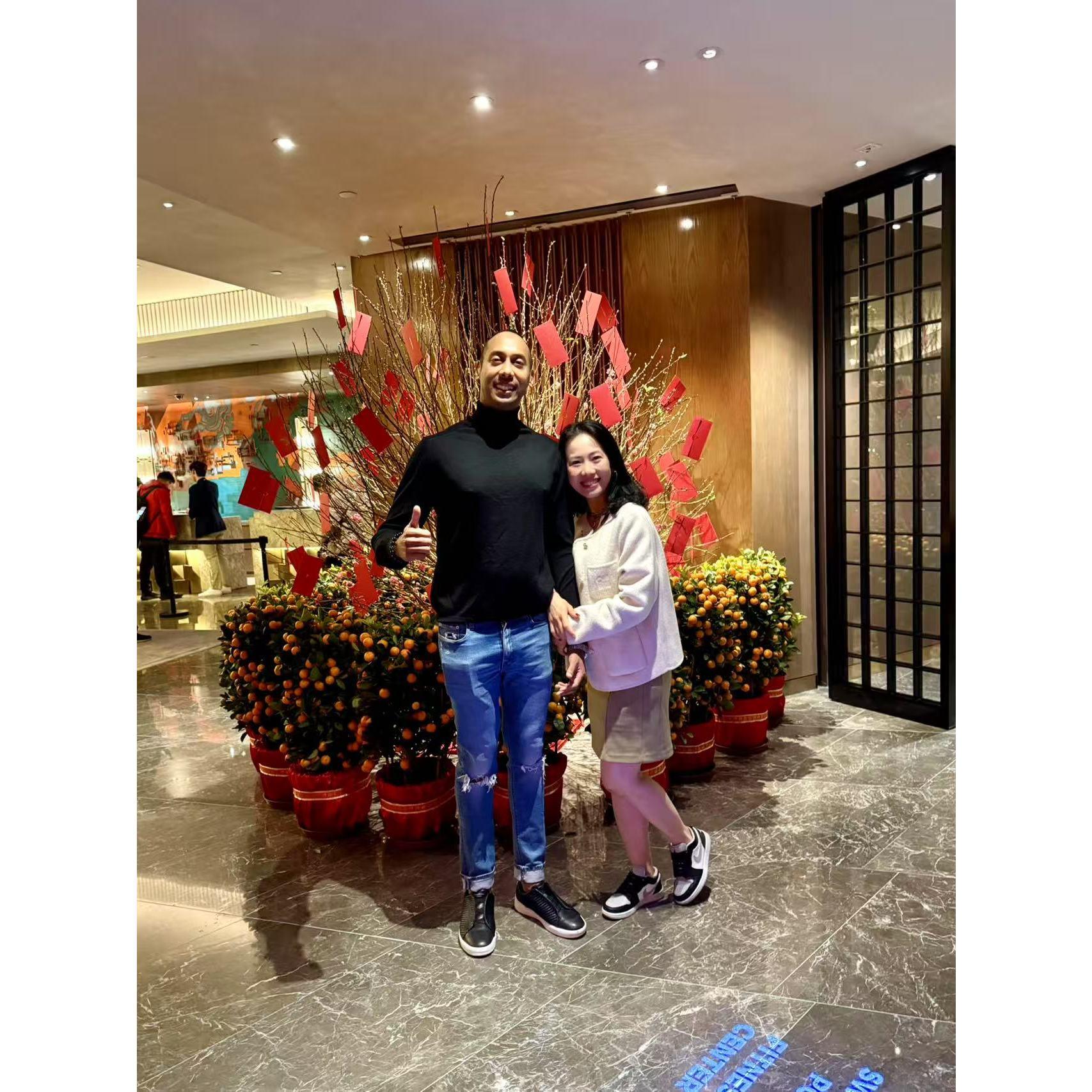 “Hong Kong vibes: chilling under the lucky red packet tree, where fortune (and maybe some good snacks) are always in the air.”