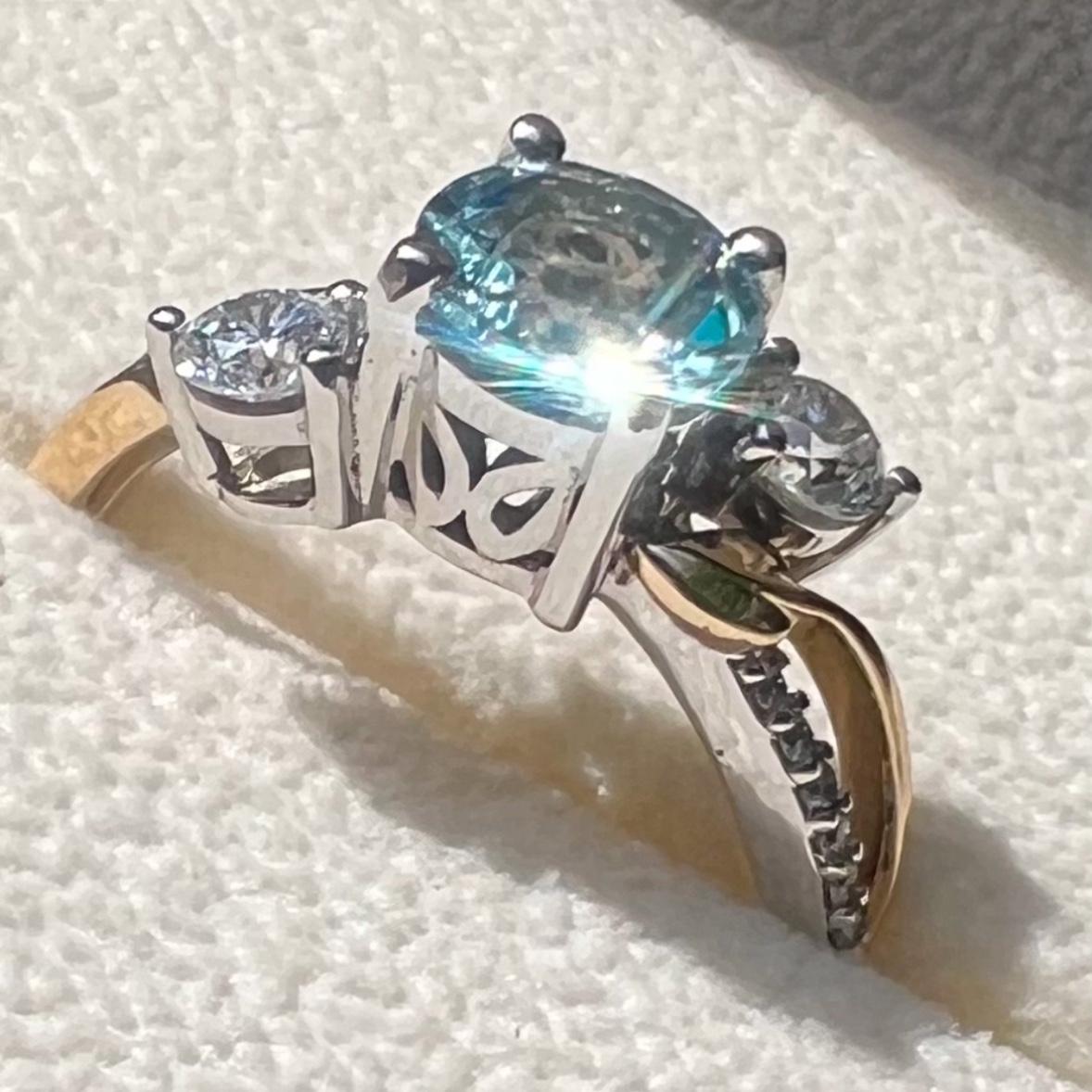 The ring. Aquamarine for Perry’s birthstone in a bouquet of diamonds and gold leaves.
