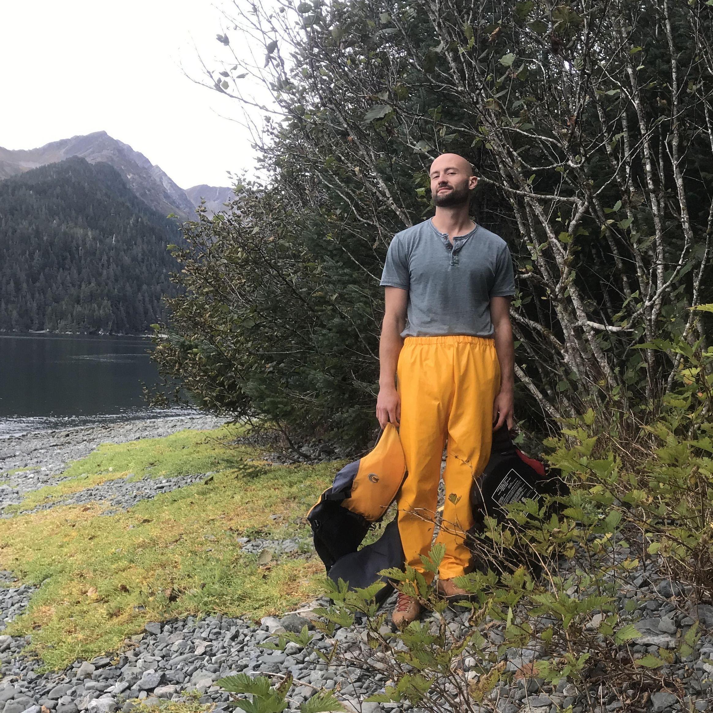 An unamused Andrew in big rain pants at a cabin for my birthday in Alaska - which was on an island! Sept. 2019