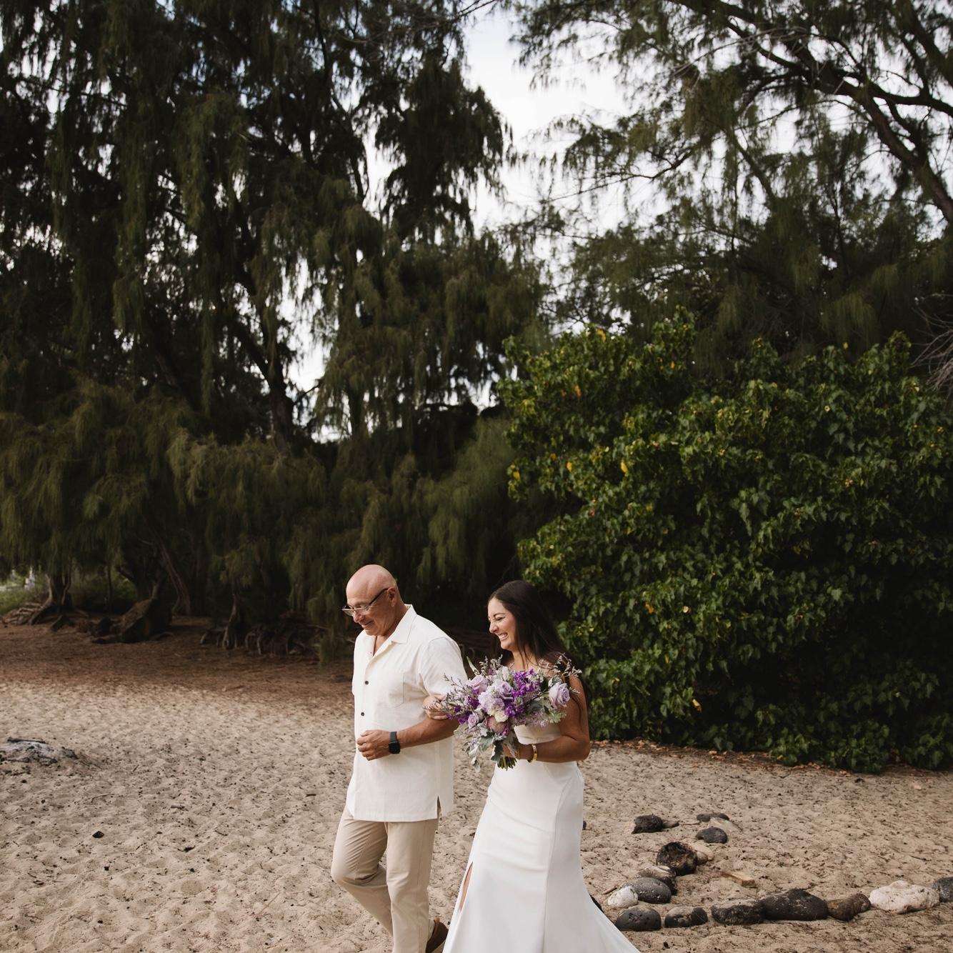 Cassie's dad walked her down the aisle. (Walking on the beach in a wedding dress was a workout)